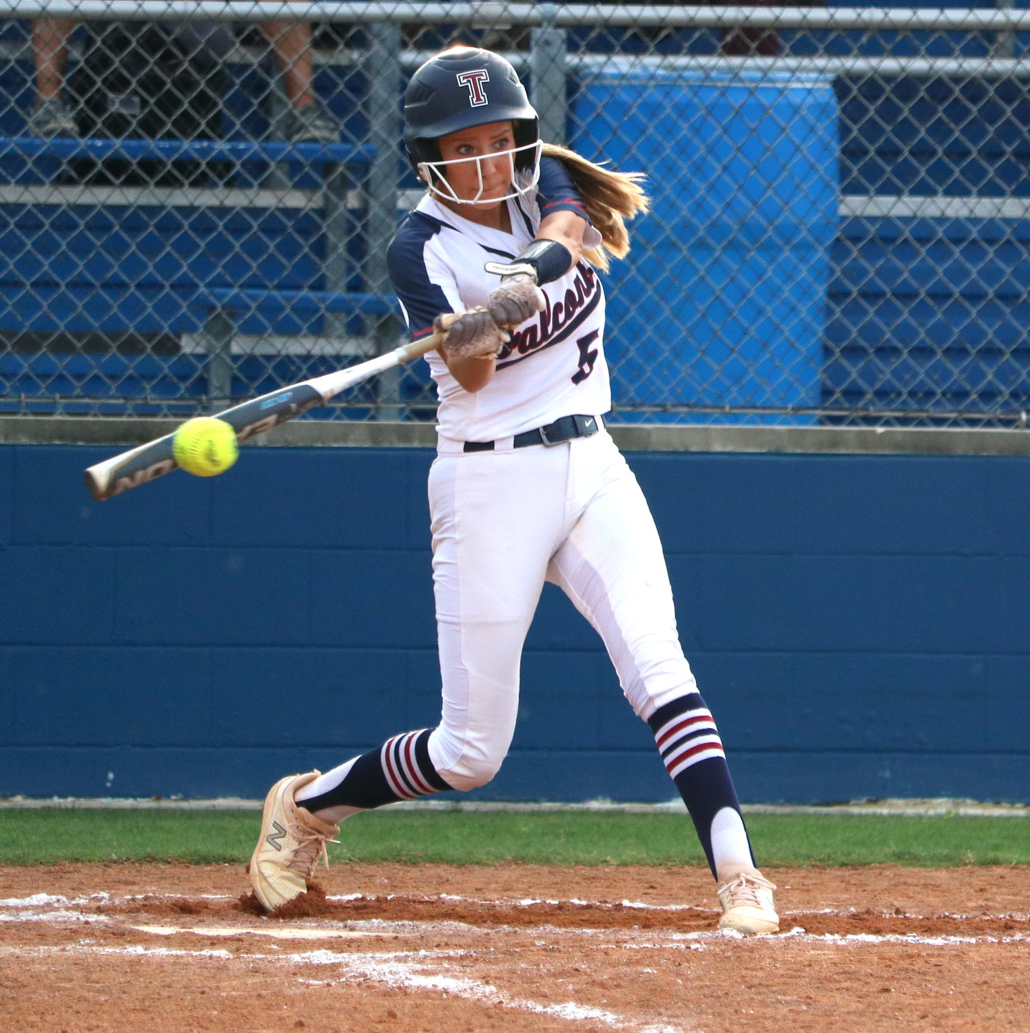 Madison Besselman hits during Thursday’s bi-district game between Tompkins and George Ranch at the Tompkins softball field.