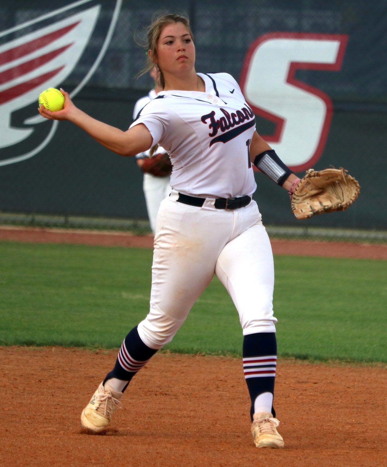 Kaitlyn Scribner throws a ball to first base during Thursday’s bi-district game between Tompkins and George Ranch at the Tompkins softball field.