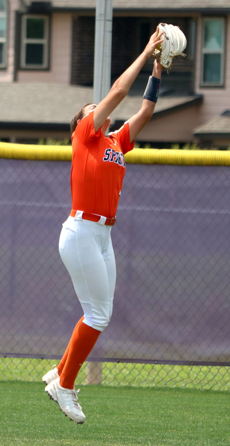 Meghan Kelly jumps to make a catch in center field during Saturday’s bi-district round game between Seven Lakes and Ridge Point at the Ridge Point softball field.