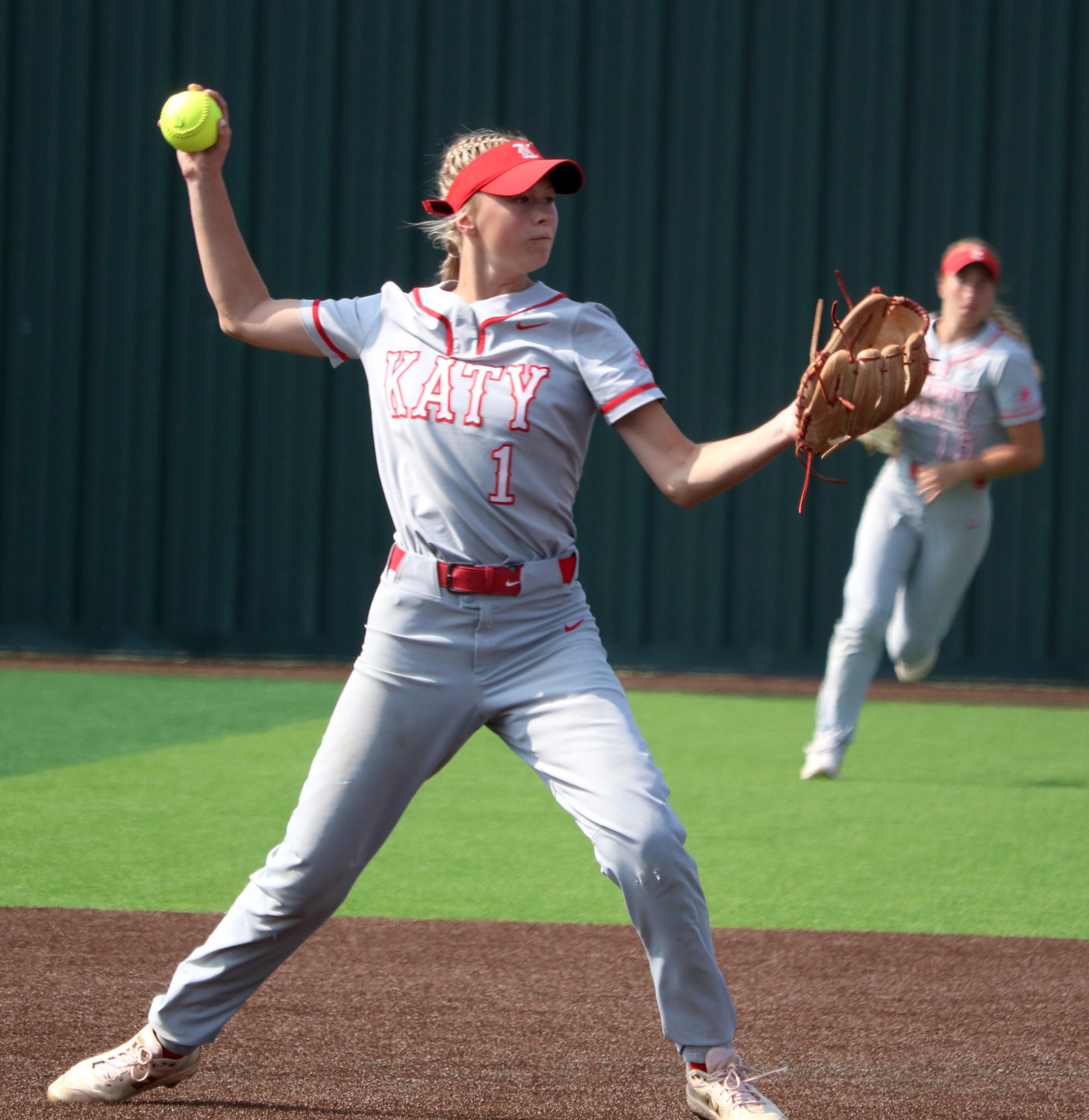Peyton Watson throws to first base during Saturday’s area round game between Katy and Cy-Fair at Cy-Lakes.