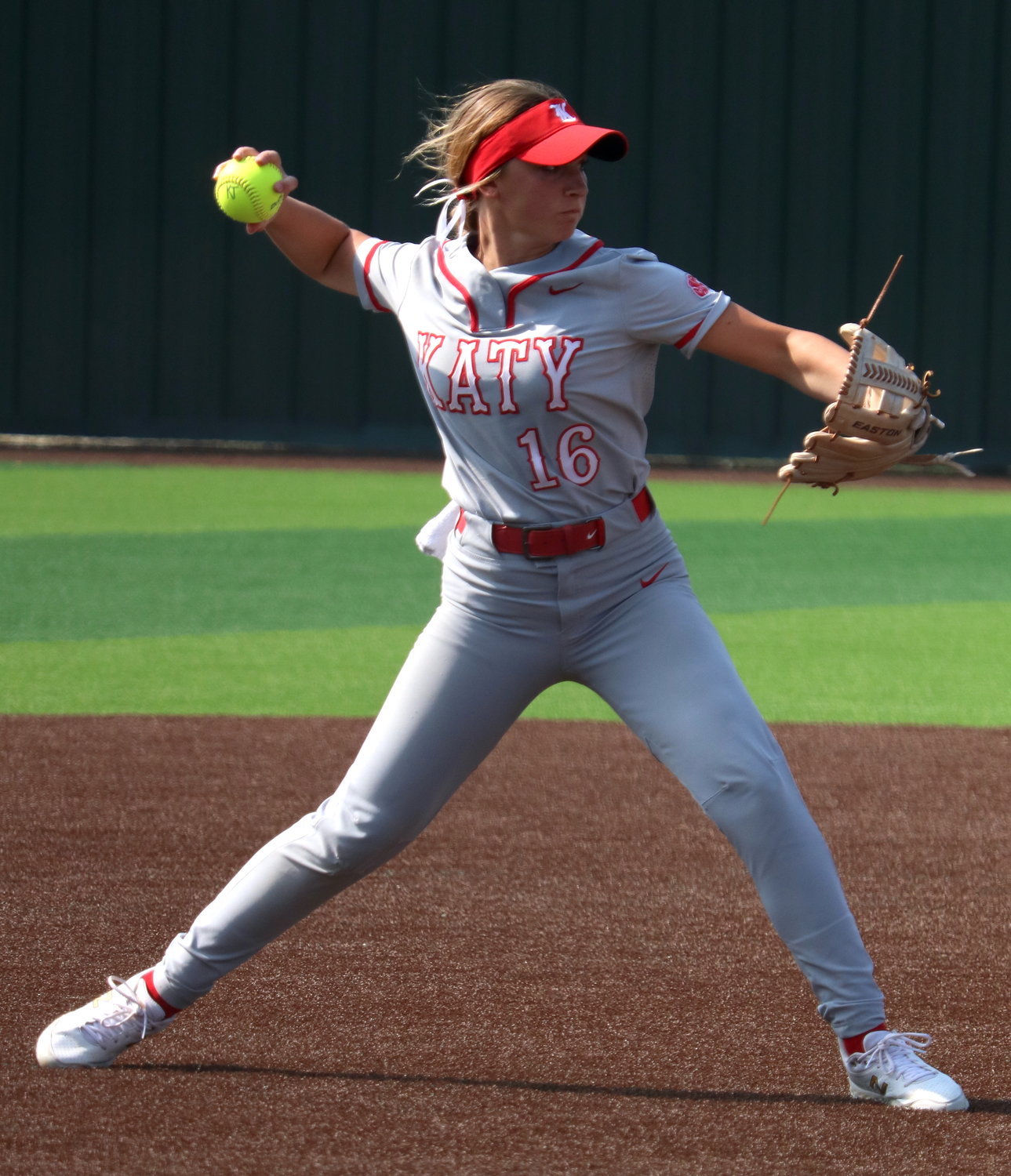 Hailey Gore throws to first base during Saturday’s area round game between Katy and Cy-Fair at Cy-Lakes.