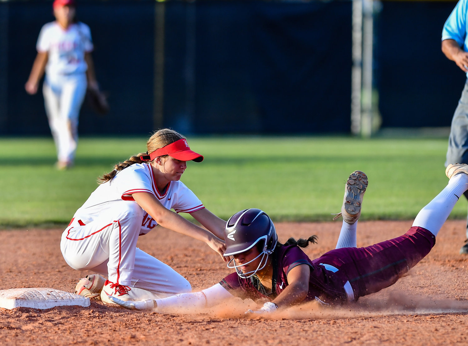 May 13, 2022: Katy's Avery Porter #12 makes the tag on Cinco Ranch's Gissel Morales #7 for the out during the Regional Quarterfinal playoff between Katy and Cinco Ranch at Katy HS. (Photo by Mark Goodman / Katy Times)