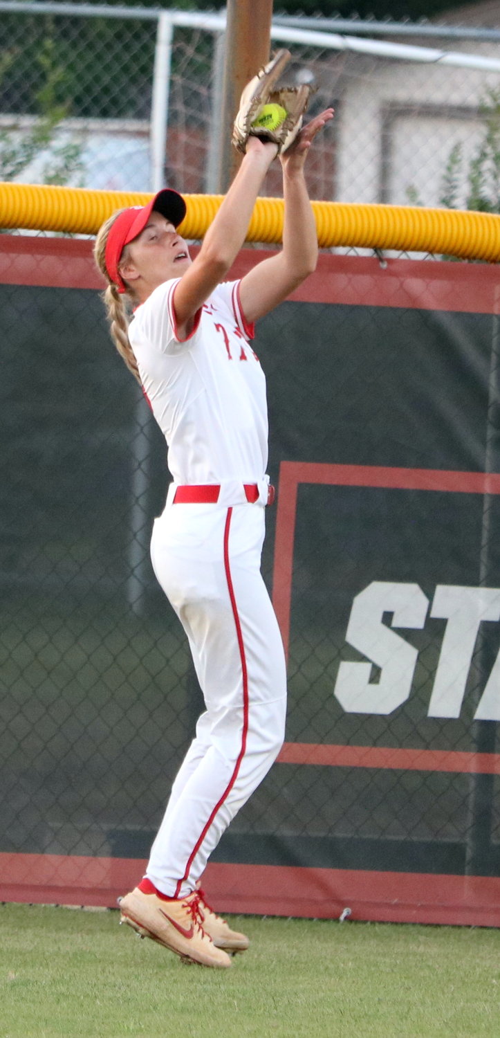 Ashtyn Reichardt jumps to make a catch in center field during Wednesday’s Class 6A Regional Semifinal game between Katy and Pearland at the Katy softball field.