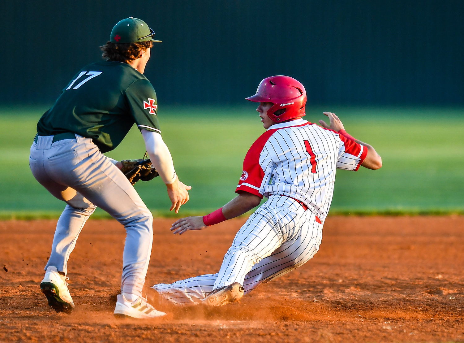 iKaty's Graham Laxton (1) is tagged out by Strake Jesuits Shane Pellegrino (17) as he slides into third base during the third inning during a Region III-6A SemiFinals baseball game between Katy and Strake Jesuit at Mayde Creek High School, Friday, May 27, 2022.
