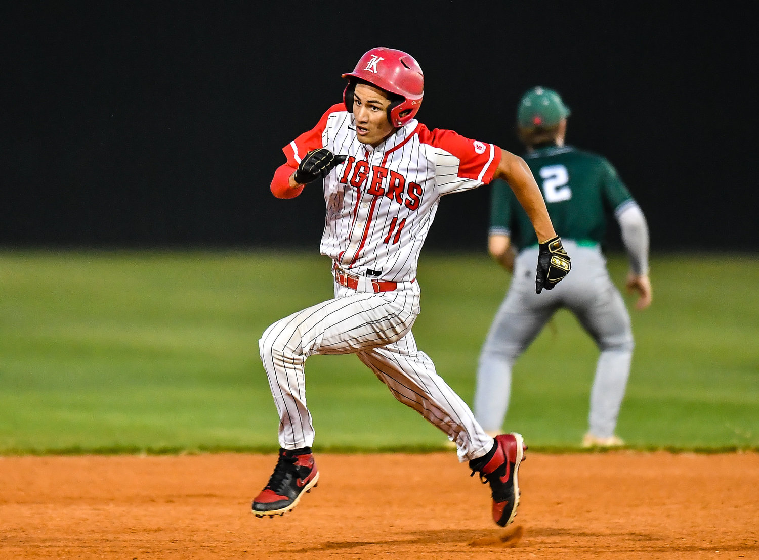 Katy's Dominic Melchor (11) heads for third base for a triple during the fourth inning during a Region III-6A SemiFinals baseball game between Katy and Strake Jesuit at Mayde Creek High School, Friday, May 27, 2022.