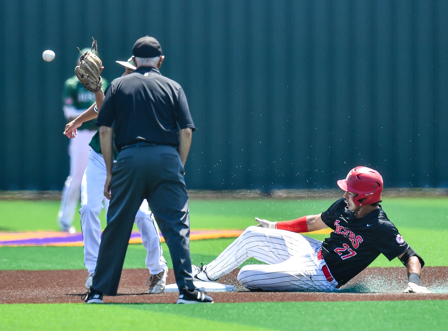 Katy's Jhonnatan Ferrebus (27) slides safely into second base during the sixth inning of game three during a Region III-6A Regional SemiFinals baseball game between Katy and Strake Jesuit at Jersey Village High School, Saturday, May 28, 2022.