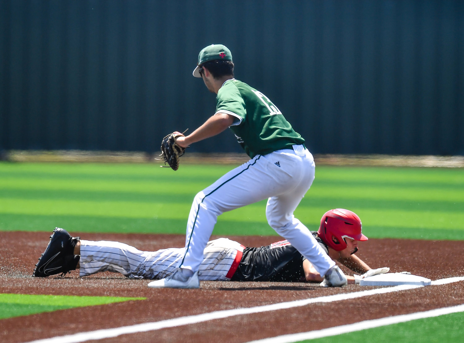 Katy's Jr Ceyanes (17) gets back to first base in a pick off attempt during the sixth inning of game three during a Region III-6A Regional SemiFinals baseball game between Katy and Strake Jesuit at Jersey Village High School, Saturday, May 28, 2022.