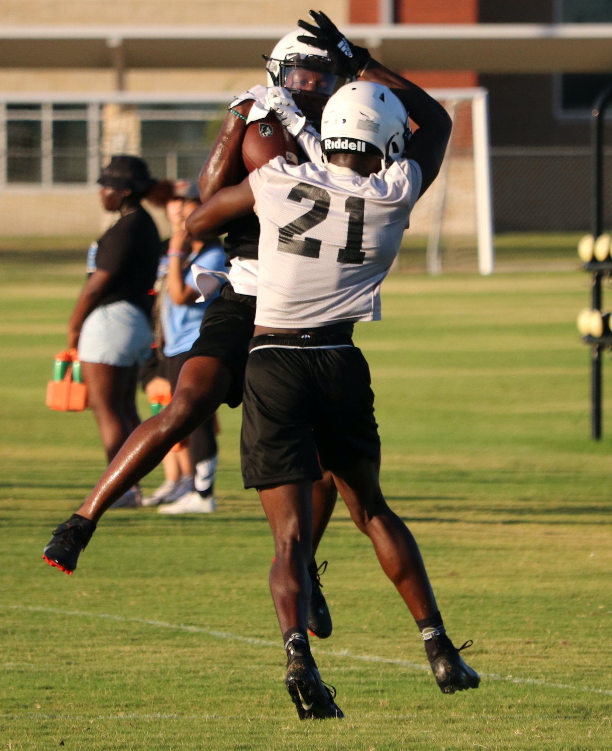 Jason Blue makes a jumping catch over a defensive back during Paetow’s practice on Monday morning.
