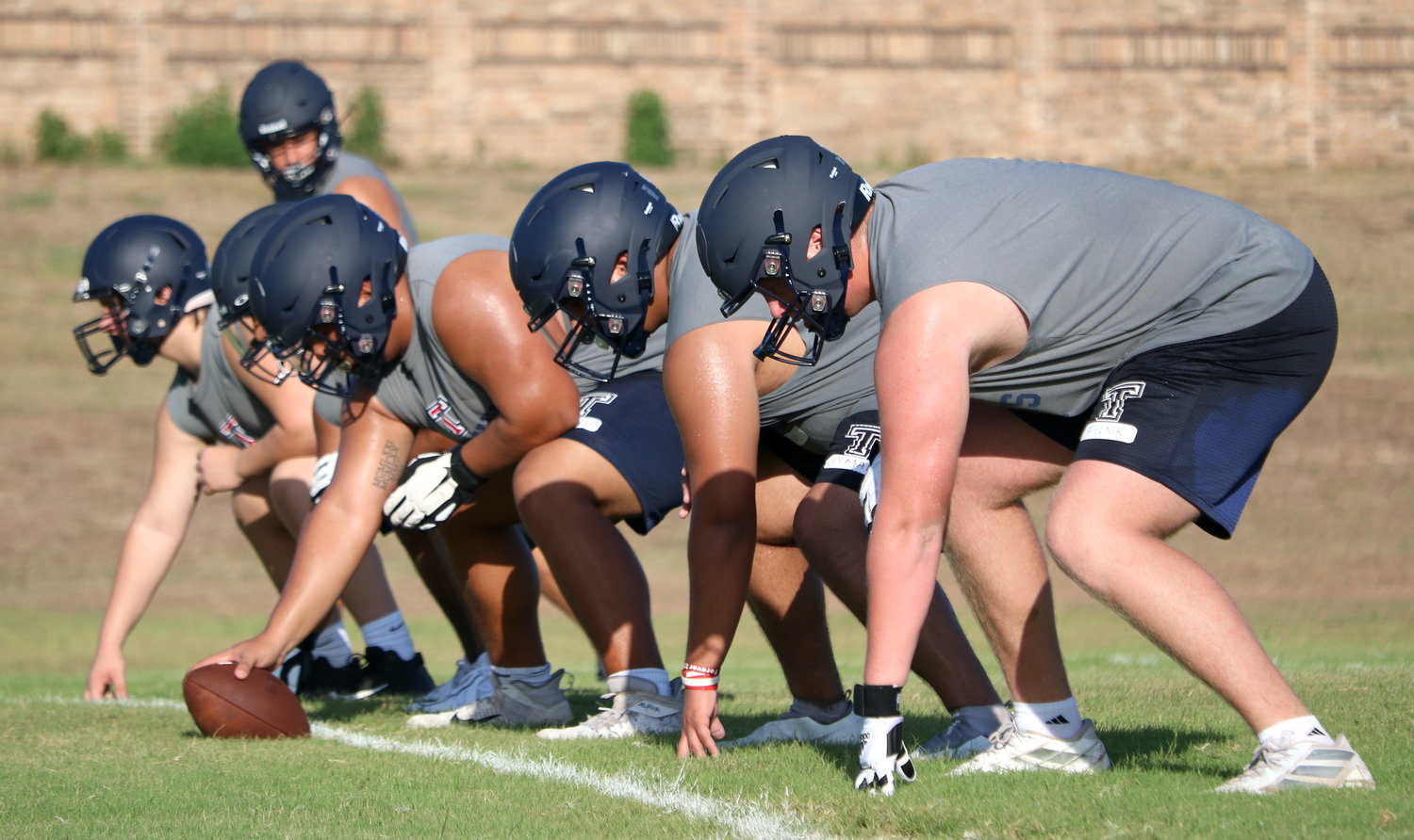 Tompkins offensive line lines up for a play during Tuesday’s practice.