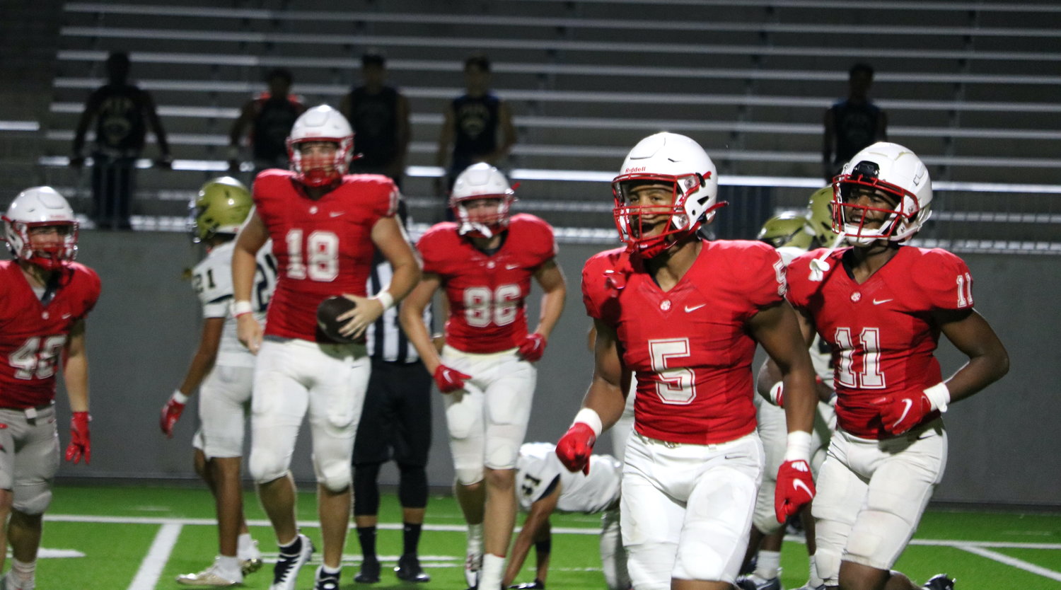 Katy’s defense celebrates after forcing and recovering a fumble during Katy’s scrimmage against Klein Collins on Friday at Legacy Stadium.