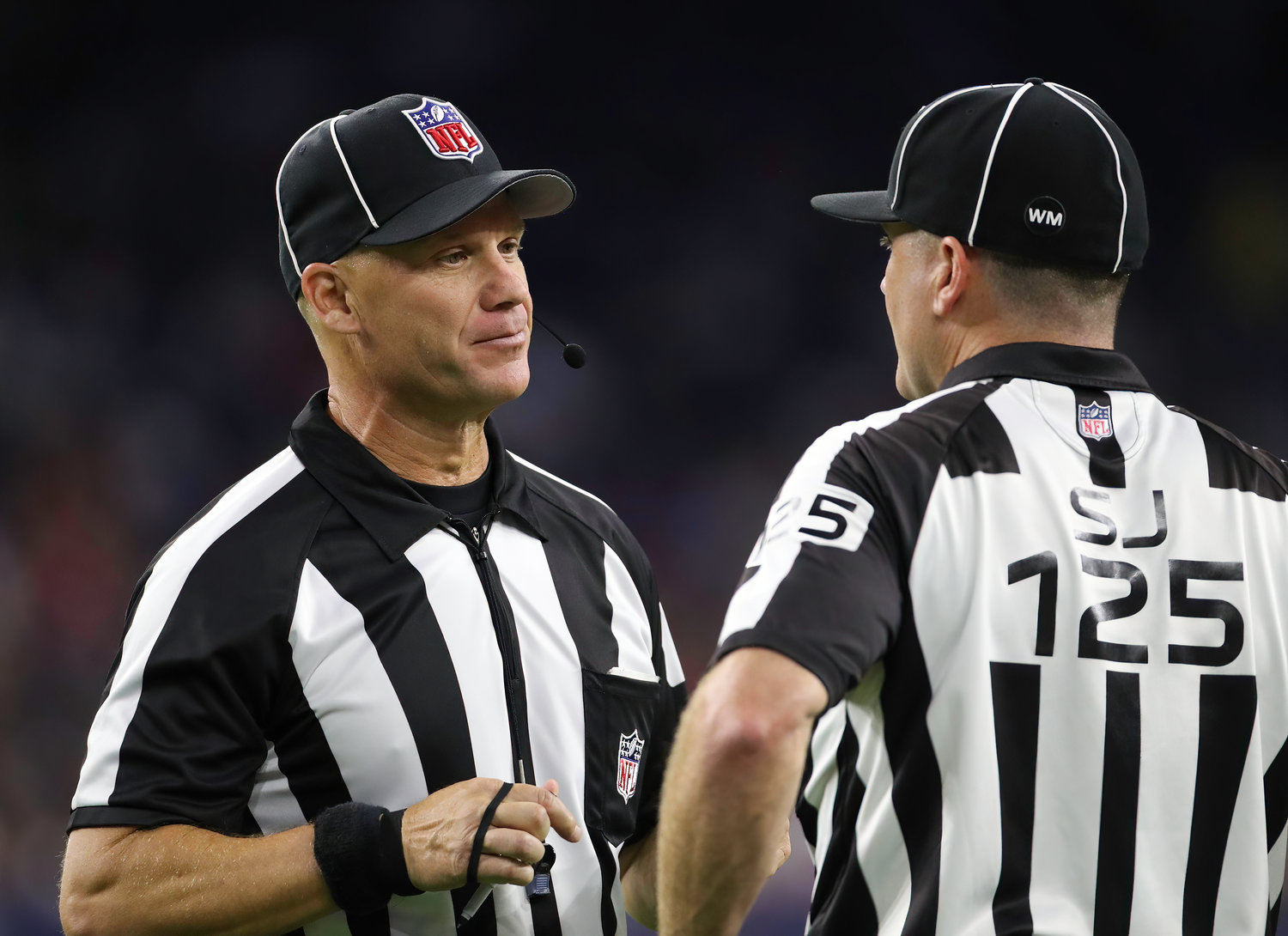 Back judge Rich Martinez (39) talks with side judge Chad Hill (125) during an NFL preseason game between the Texans and the 49ers in Houston, Texas, on August 25, 2022.