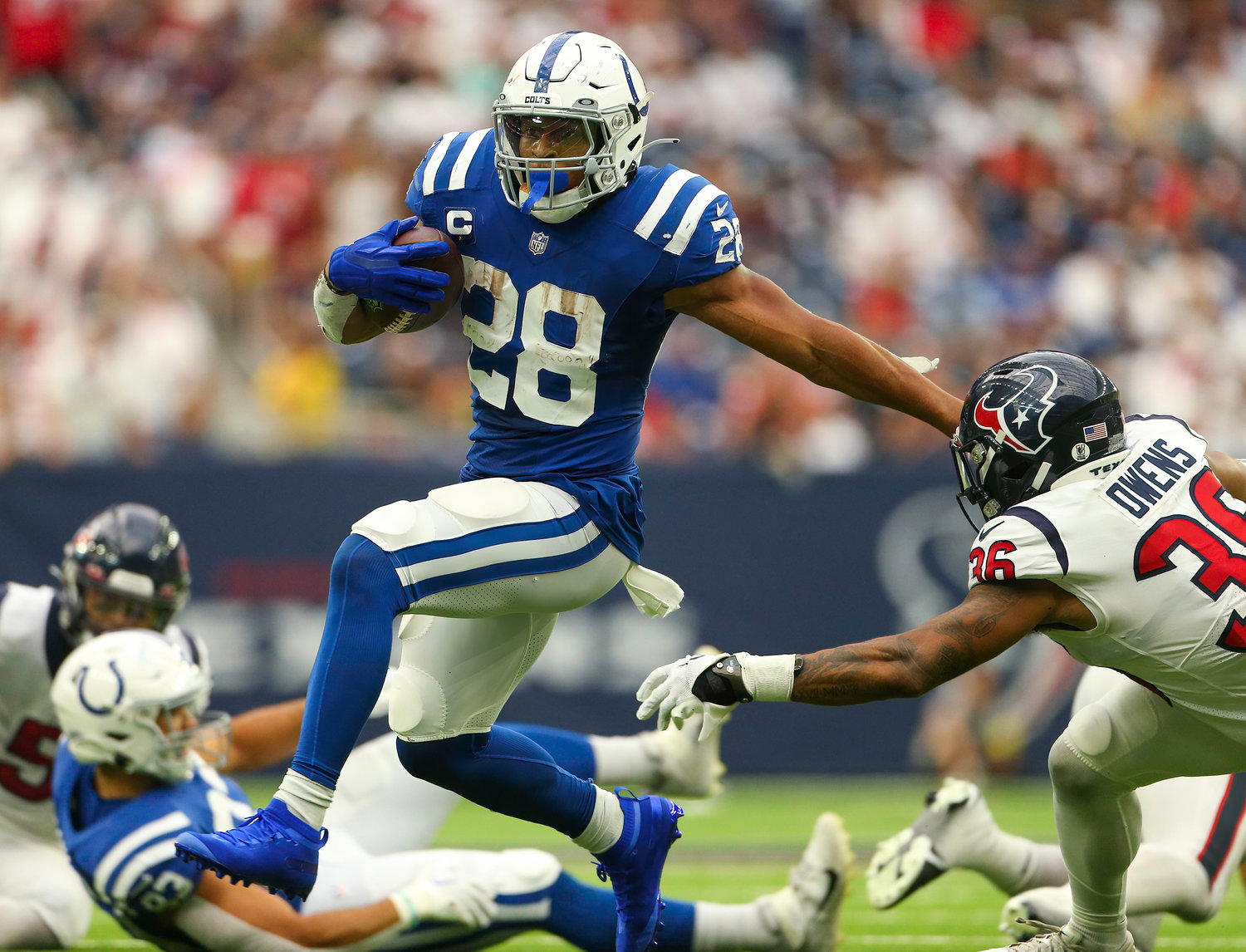 Indianapolis Colts running back Jonathan Taylor (28) attempts to evade Houston Texans safety Jonathan Owens (36) on a carry during an NFL game between the Texans and the Colts on September 11, 2022 in Houston. The game ended in a 20-20 tie after a scoreless overtime period.