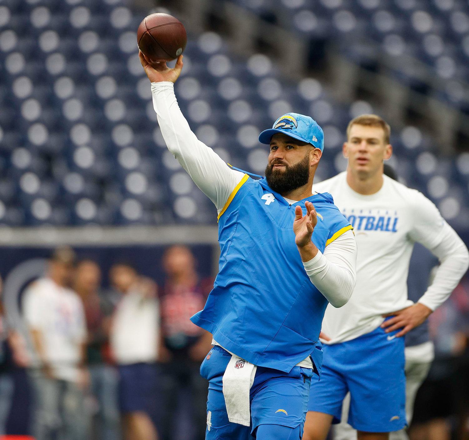 Chargers quarterback Chase Daniel (4) throws during warmups as quarterback Easton Stick (2) looks on before the start of an NFL game between the Texans and the Chargers on Oct. 2, 2022 in Houston.