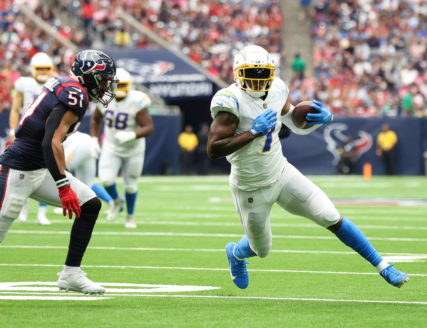 Chargers tight end Gerald Everett (7) carries the ball after a catch during an NFL game between the Texans and the Chargers on Oct. 2, 2022 in Houston. The Chargers won 34-24.