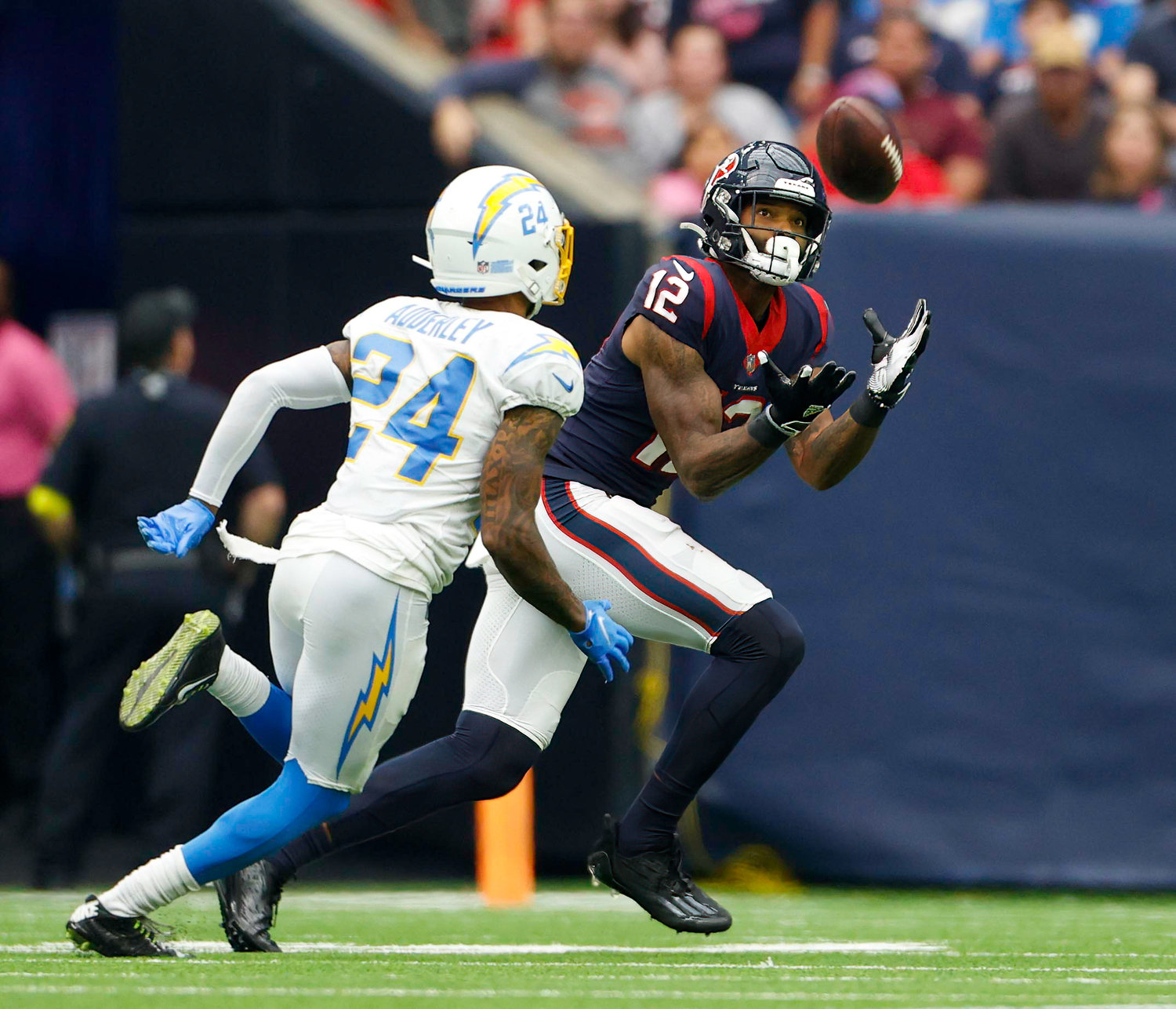 Texans wide receiver Nico Collins (12) brings in a 58-yard pass down to the 18 yard line to set up a Houston touchdown in the 4th quarter of an NFL game between the Texans and the Chargers on Oct. 2, 2022 in Houston. The Chargers won 34-24.