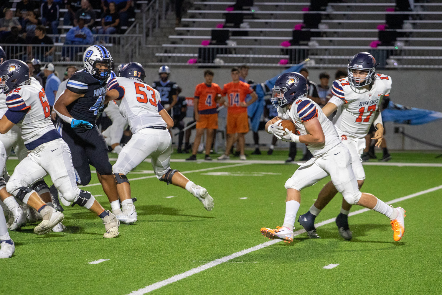 Seven Lakes Barrett Hudson takes a handoff during Thursday's game between Paetow and Seven Lakes at Legacy Stadium.