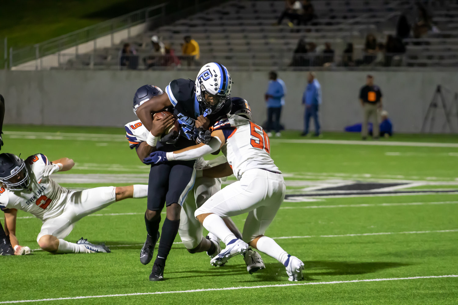 Paetow's Jamarious Bates fights through defenders during Thursday's game between Paetow and Seven Lakes at Legacy Stadium.