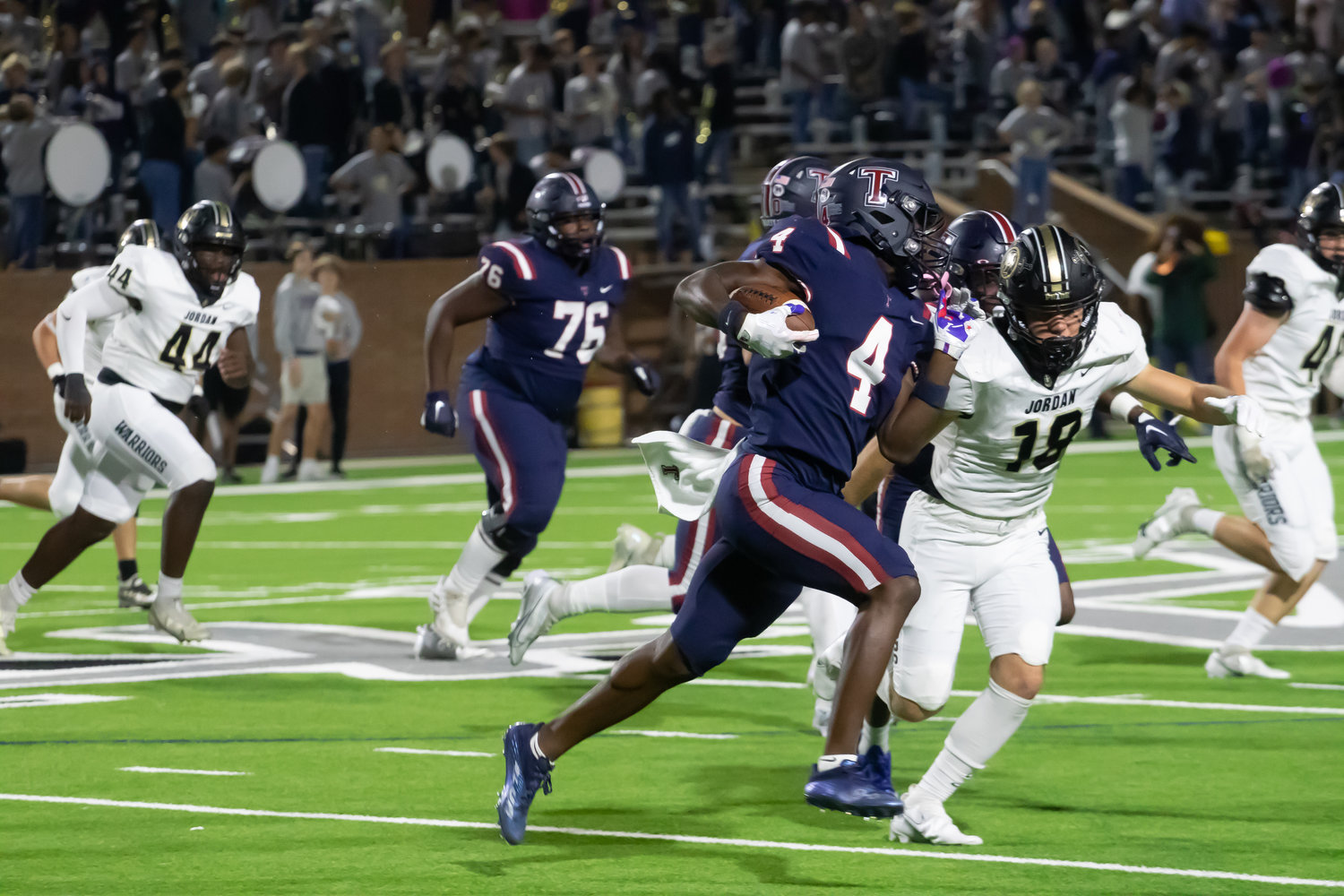 Tompkins' Matthew Ogunrin breaks to the outside during Friday's game between Tompkins and Jordan at Rhodes Stadium.
