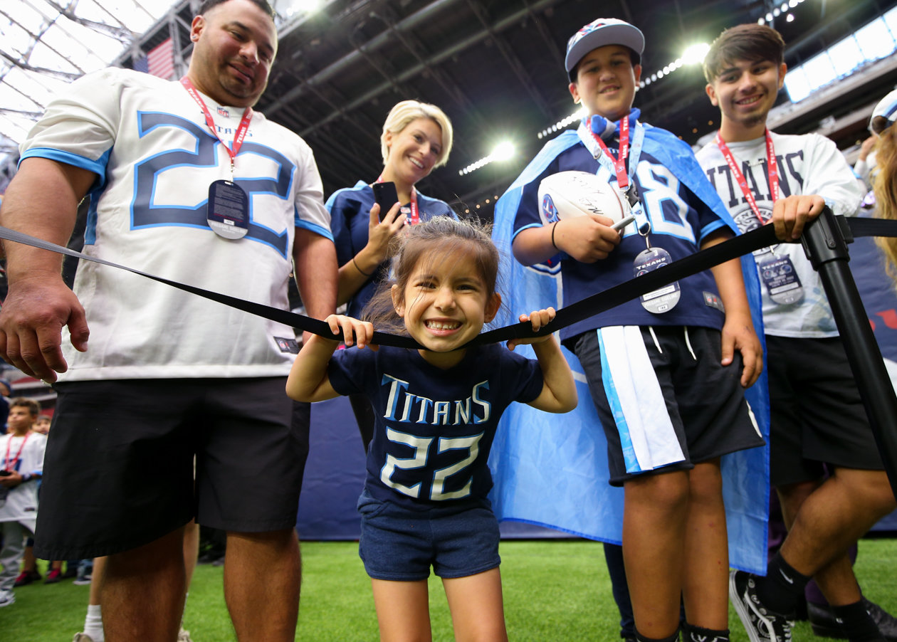 Tennessee Titans fans wait on the field for a chance at play autographs before the start of an NFL game between the Texans and the Titans on Oct. 30, 2022 in Houston.