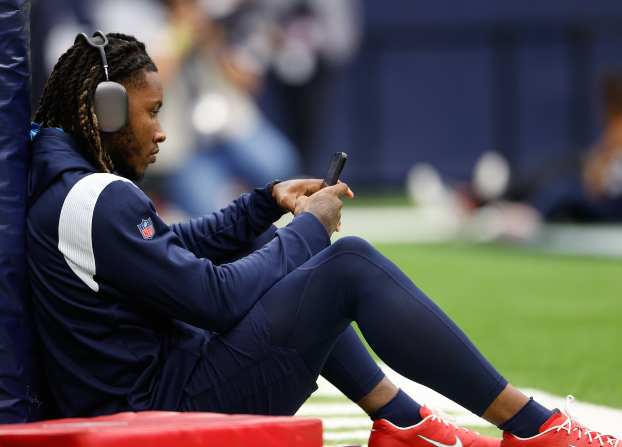 Titans cornerback Lonnie Johnson (20) sits against a goalpost before team warmups ahead of an NFL game between the Texans and the Titans on Oct. 30, 2022 in Houston.