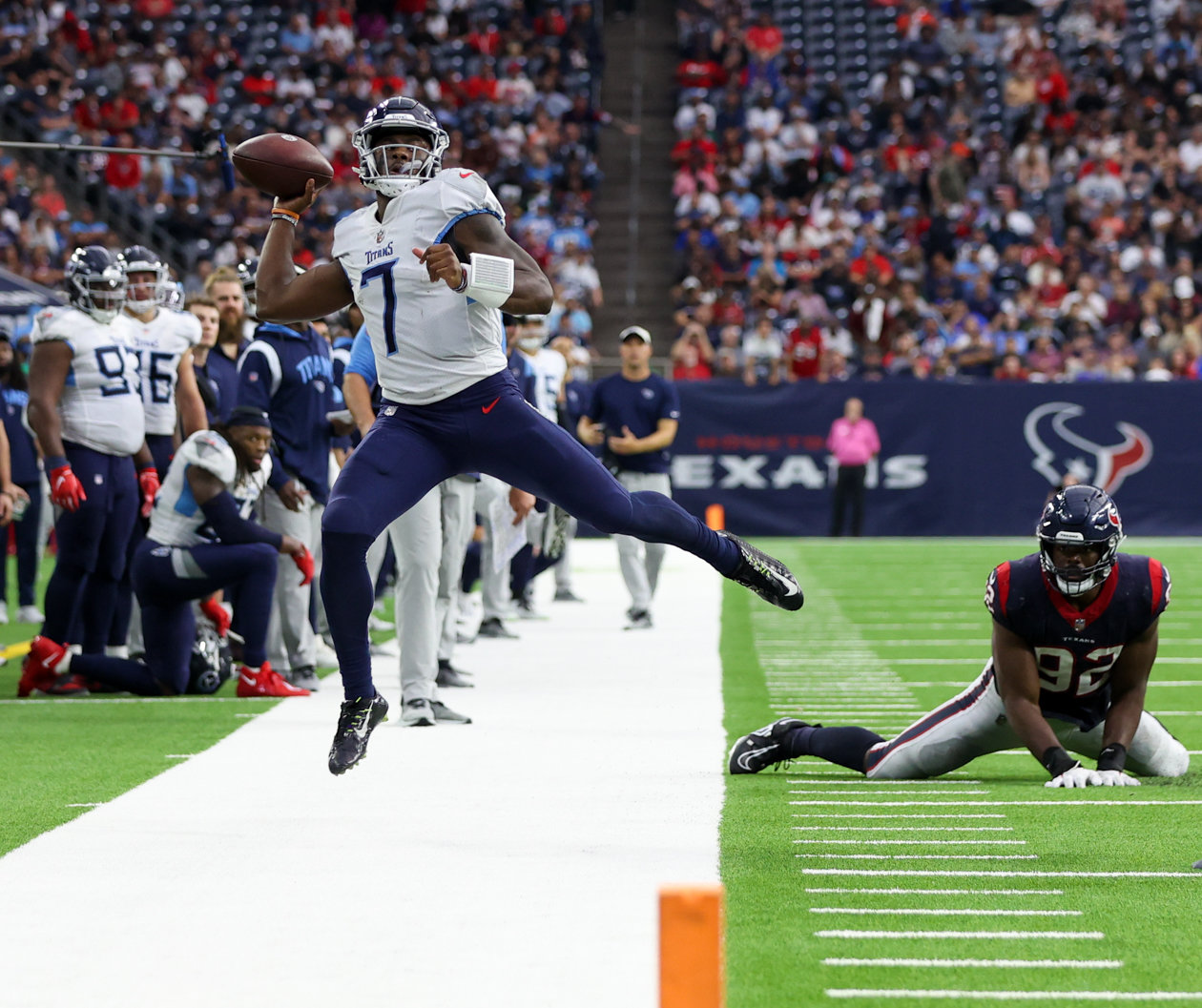Titans quarterback Malik Willis (7) passes the ball downfield while leaping out of bounds during an NFL game between the Texans and the Titans on Oct. 30, 2022 in Houston.