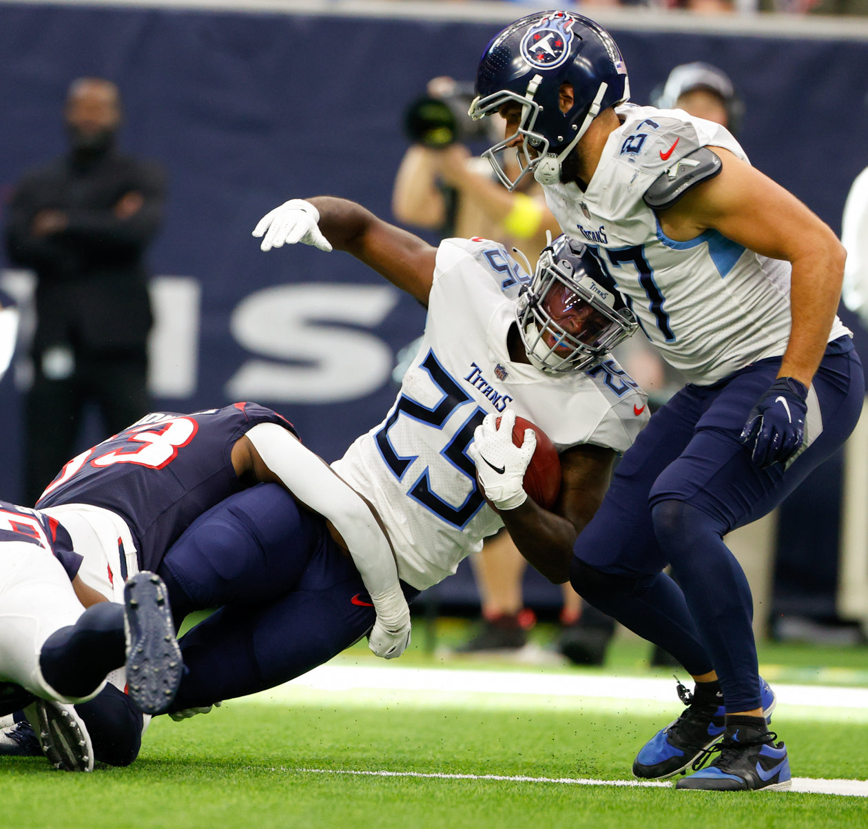 Titans running back Hassan Haskins (25) is tackled on a carry during an NFL game between the Texans and the Titans on Oct. 30, 2022 in Houston.