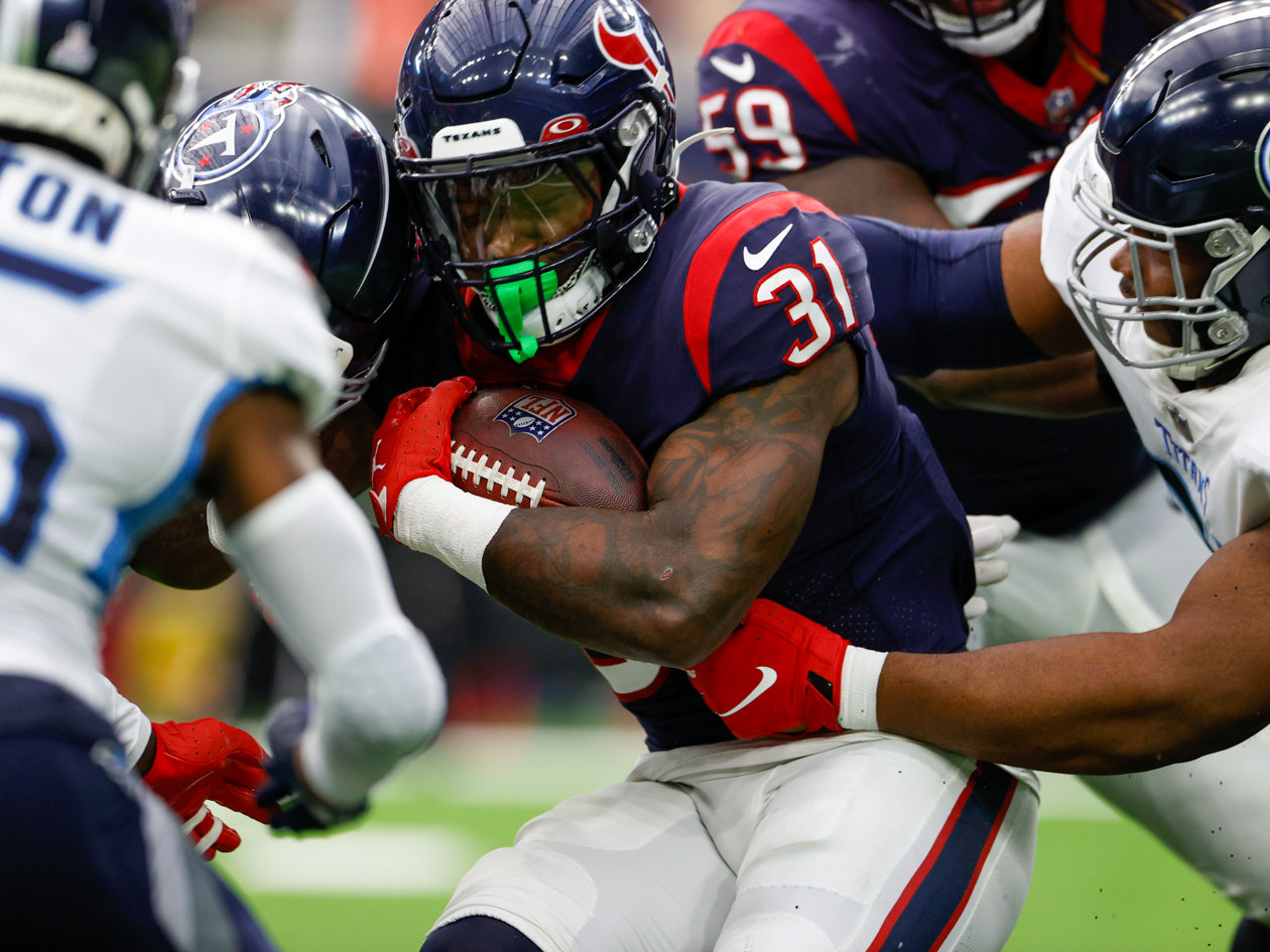 Texans running back Dameon Pierce (31) is tackled on a carry during an NFL game between the Texans and the Titans on Oct. 30, 2022 in Houston.
