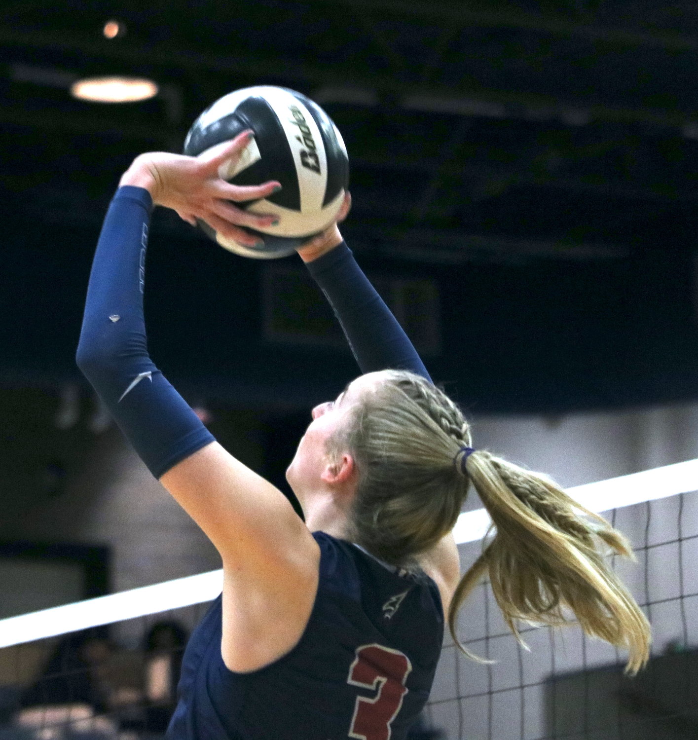 Presley Powell sets the ball during Tuesday's match between Tompkins and Ridge Point at Wheeler Field House.