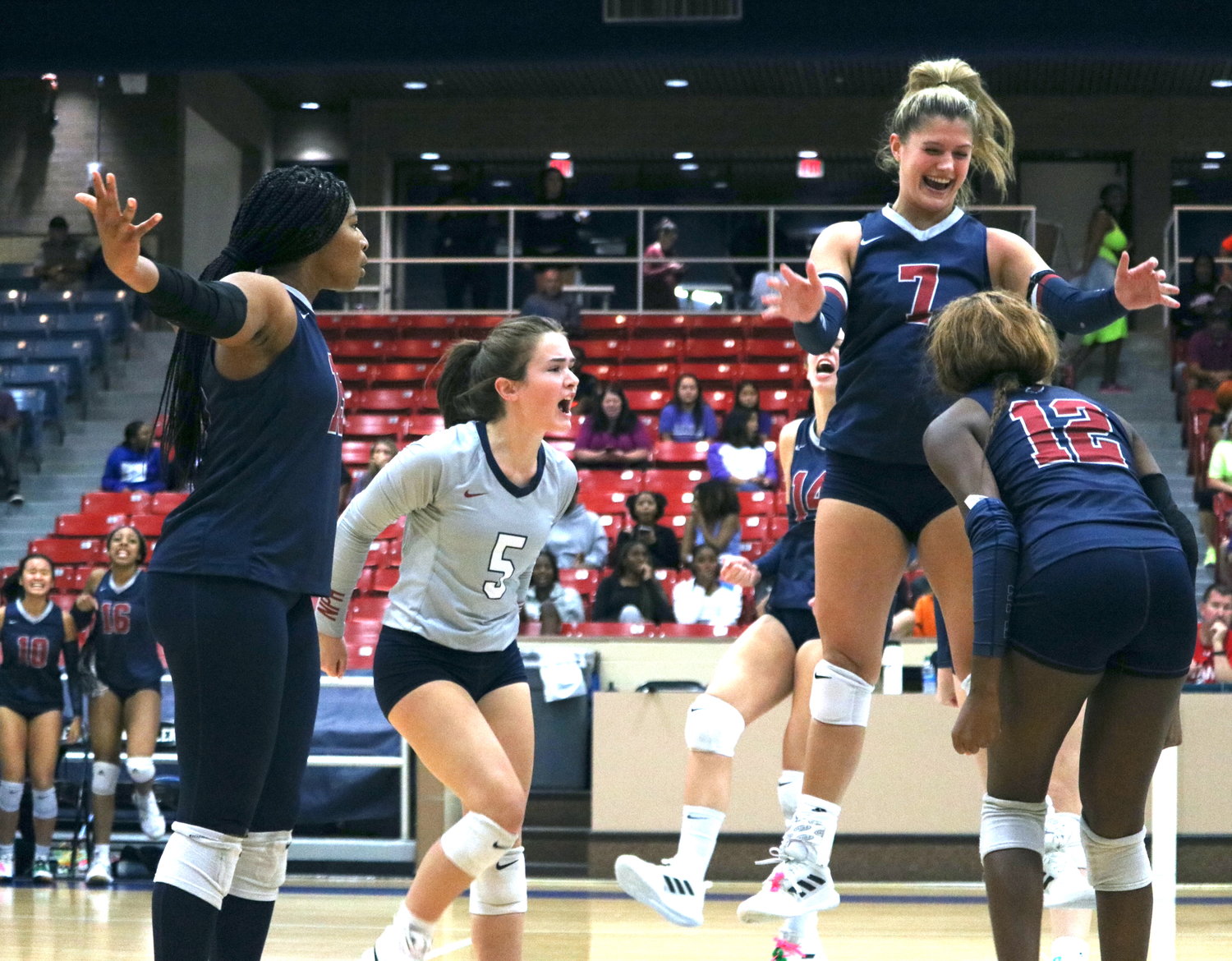 Tompkins players celebrate after a point in the first set during Tuesday's match between Tompkins and Ridge Point at Wheeler Field House.