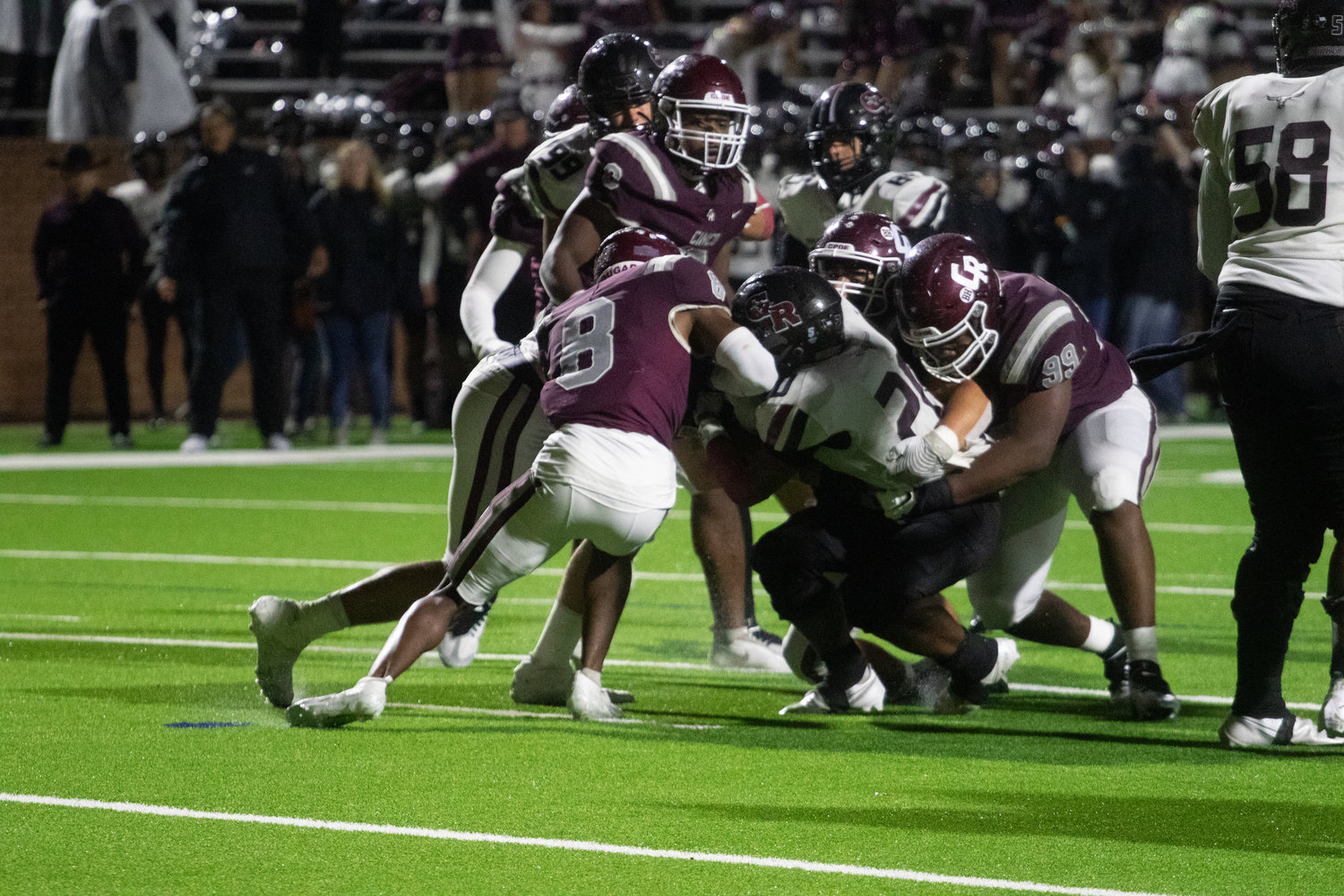 The Cinco Ranch defense makes a stop on a George Ranch ballcarrier during Friday's game between Cinco Ranch and George Ranch at Rhodes Stadium.