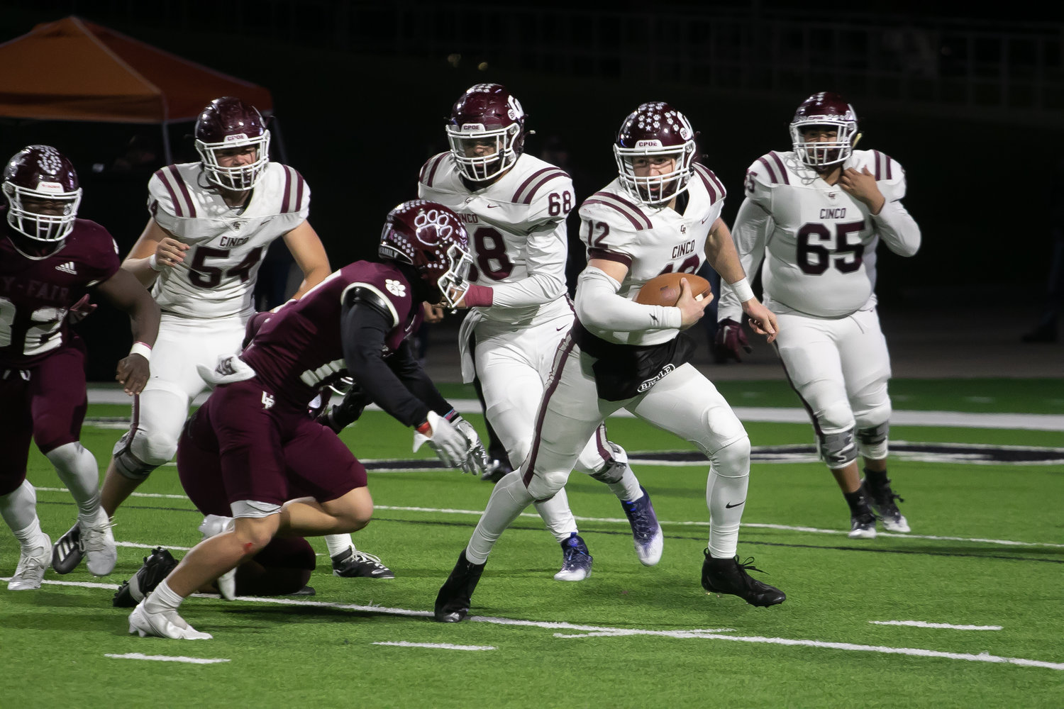 Gavin Rutherford breaks a tackle during Friday's Class 6A-Division I area round game between Cinco Ranch and Cy-Fair at Pridgeon Stadium.