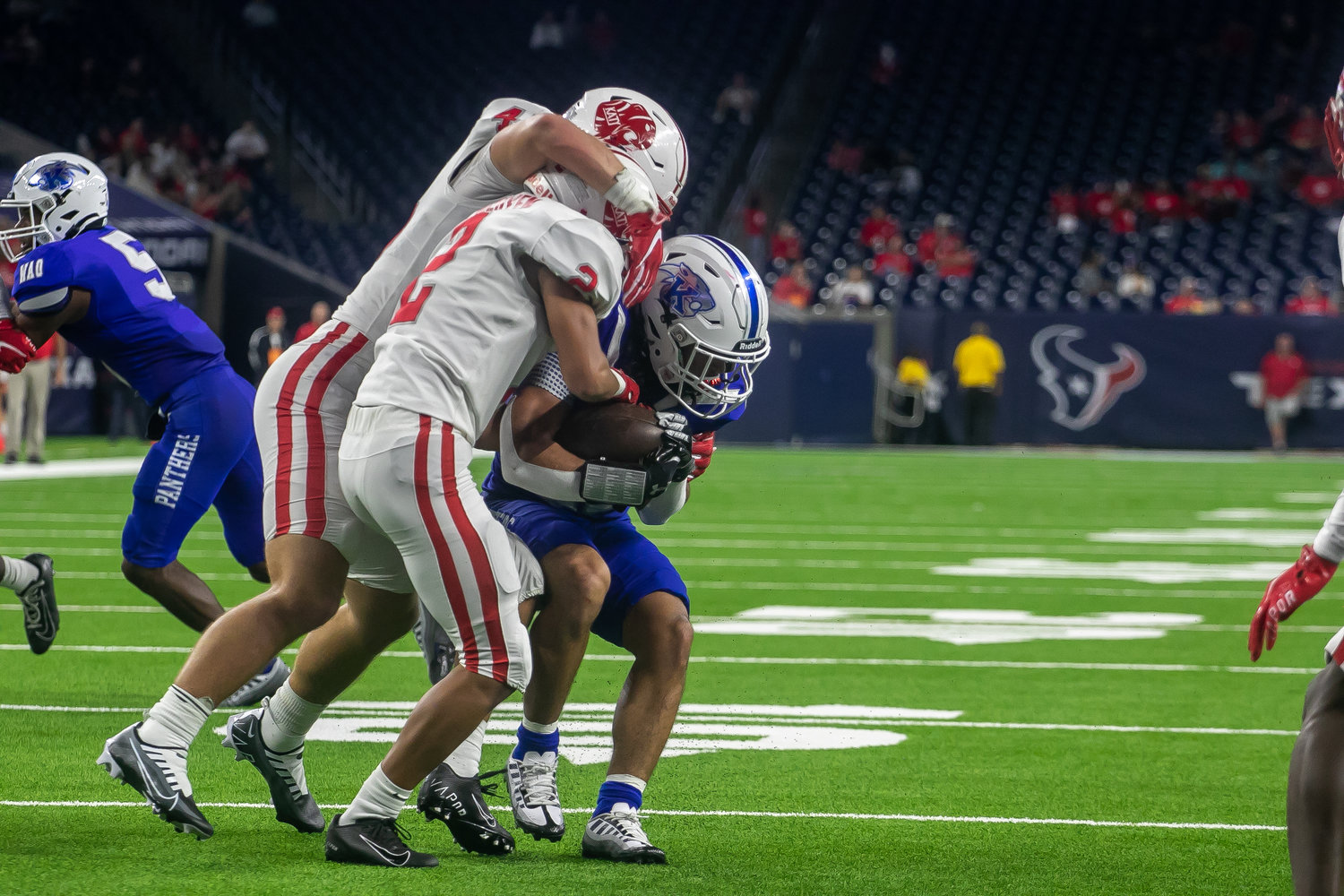 Katy players wrap up a C.E. King ballcarrier during Friday's Class 6A-Divison II Region III Final between Katy and C.E. King at NRG Stadium.