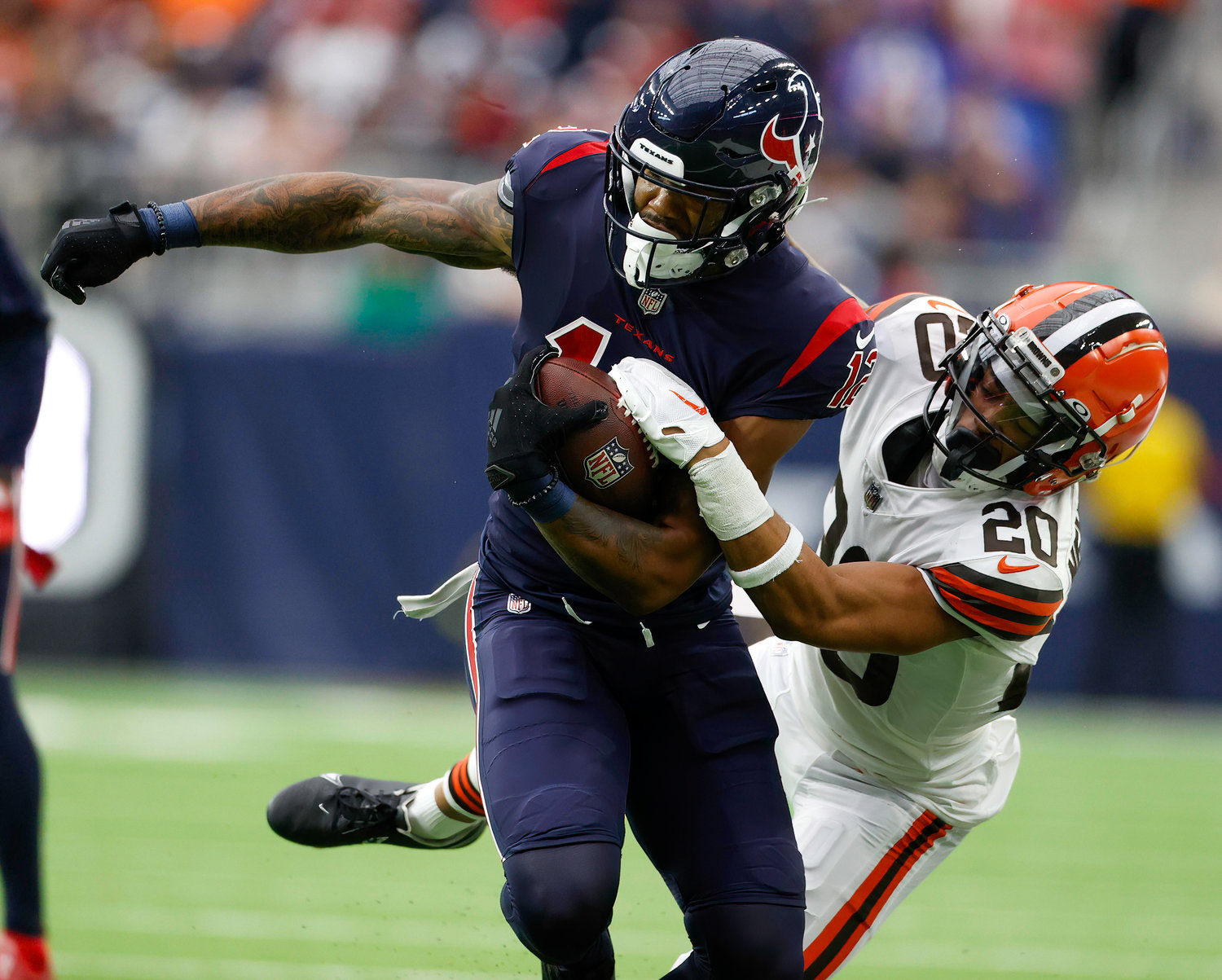 Cleveland Browns cornerback Greg Newsome II (20) works to bring down Houston Texans wide receiver Nico Collins (12) after a catch during an NFL game between the Houston Texans and the Cleveland Browns on Dec. 4, 2022, in Houston. The Browns won, 27-14.