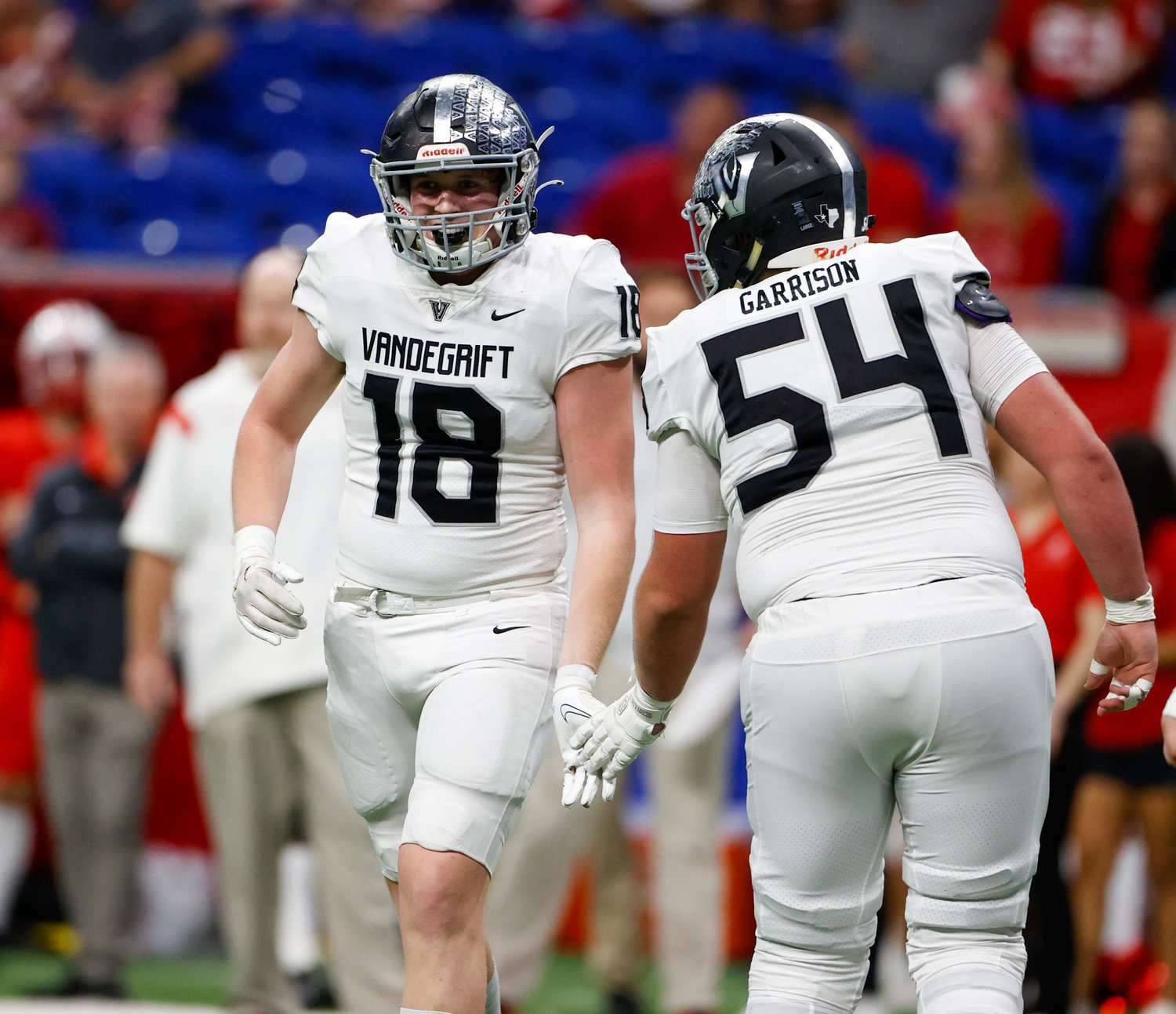 Vandegrift Vipers junior offensive lineman Gage Garrison (54) congratulates senior tight end Charlie Oliver (18) after a touchdown during the Class 6A-DII state semifinal football game between Katy and Vandegrift on Dec. 10, 2022 in San Antonio.