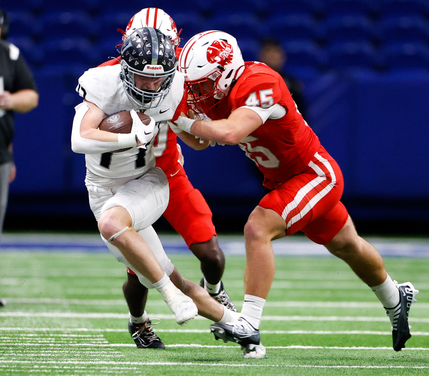 Katy linebacker Blake German (45) pushes Vandegrift Vipers senior wide receiver Beck Ormond (17) out of bounds after a catch during the Class 6A-DII state semifinal football game between Katy and Vandegrift on Dec. 10, 2022 in San Antonio.