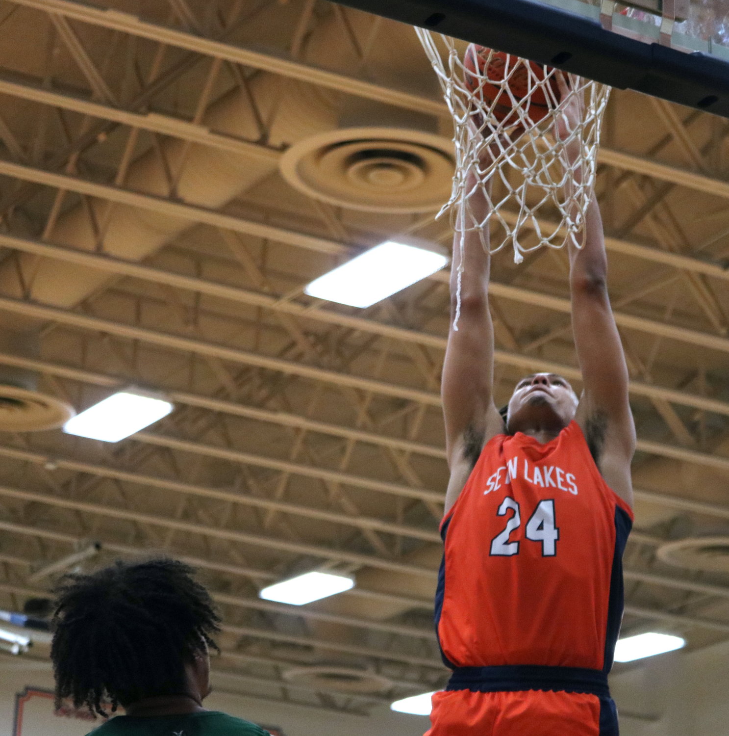 AJ Bates dunks the ball during Monday’s game between Seven Lakes and Mayde Creek at the Seven Lakes gym.