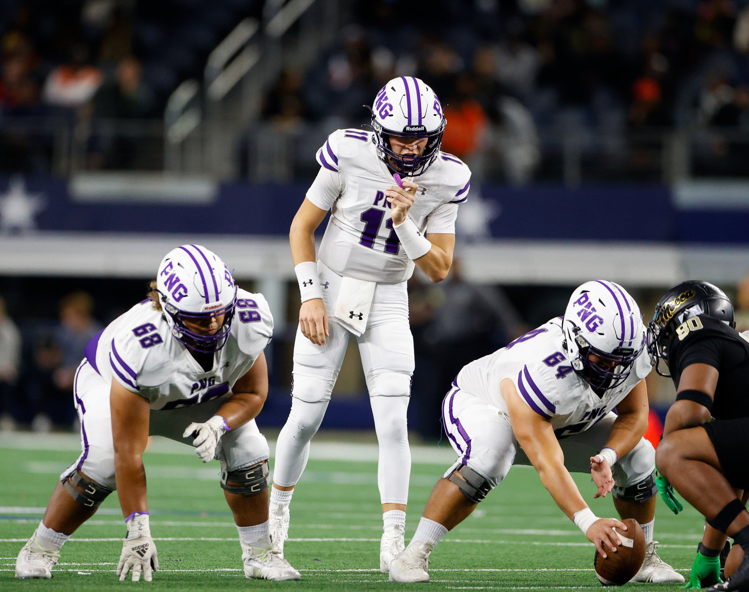 Port Neches-Groves quarterback Cole Crippen (11) prepares for a snap during the Class 5A Division II football state championship game between South Oak Cliff and Port Neches-Groves in Arlington, Texas, on Dec. 16, 2022.