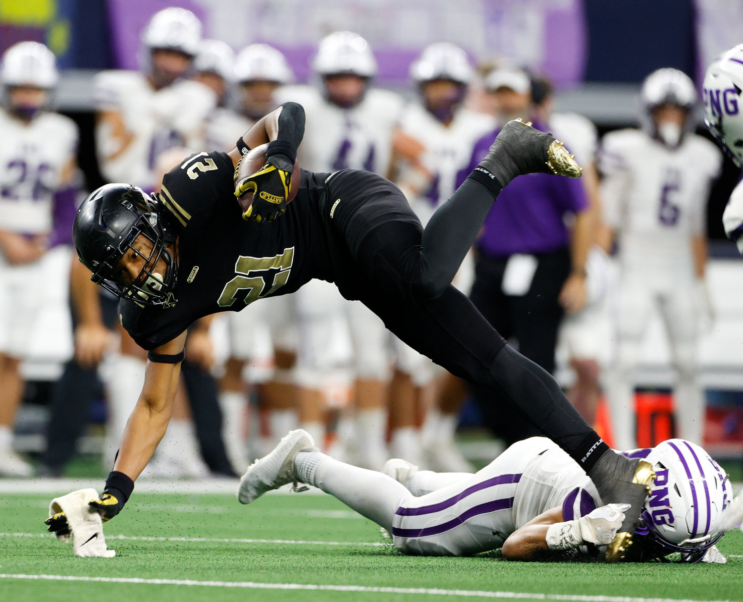 South Oak Cliff running back Danny Green (21) is upended on a carry during the Class 5A Division II football state championship game between South Oak Cliff and Port Neches-Groves in Arlington, Texas, on Dec. 16, 2022.
