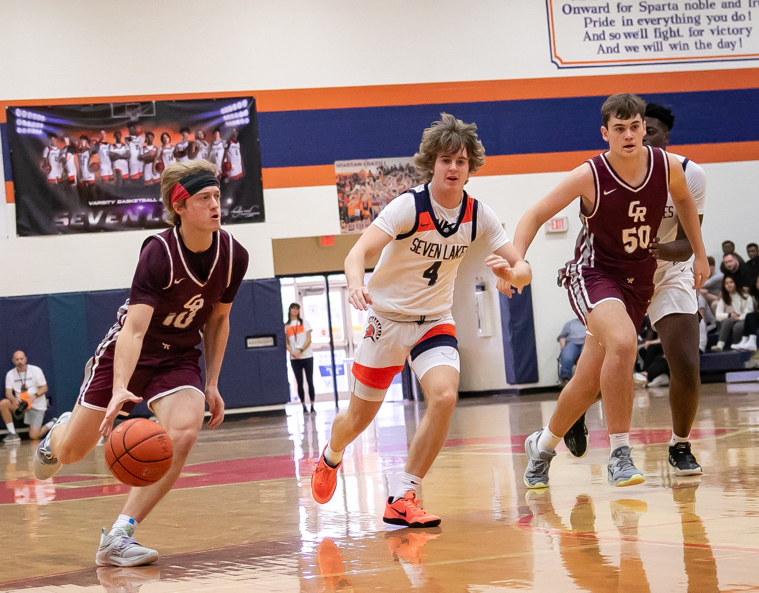 Derek Kollmansberger dribbles up the court during Saturday's game between Seven Lakes and Cinco Ranch at the Seven Lakes gym.