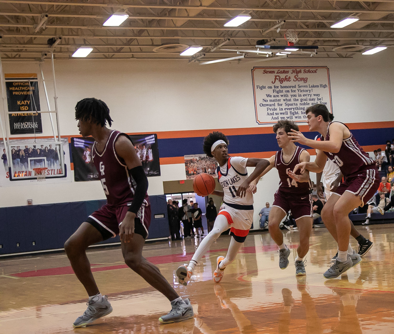 Nasir Price drives through the Cinco Ranch defense during Saturday's game between Seven Lakes and Cinco Ranch at the Seven Lakes gym.