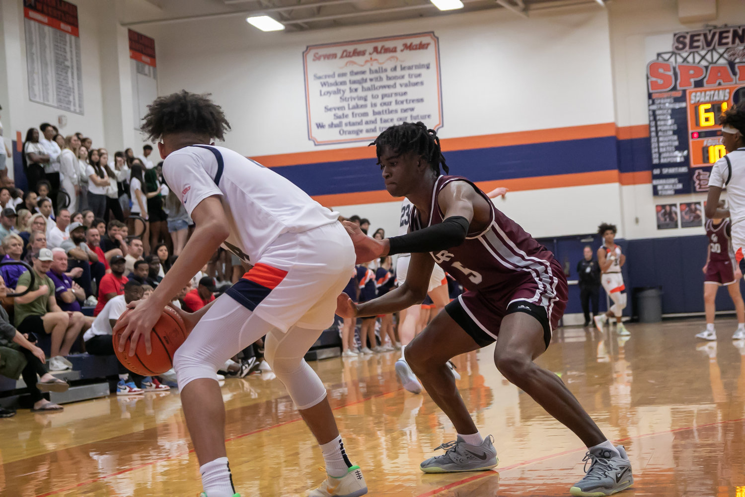 A.J. Bates backs down Emmanuel Gregory during Saturday's game between Seven Lakes and Cinco Ranch at the Seven Lakes gym.