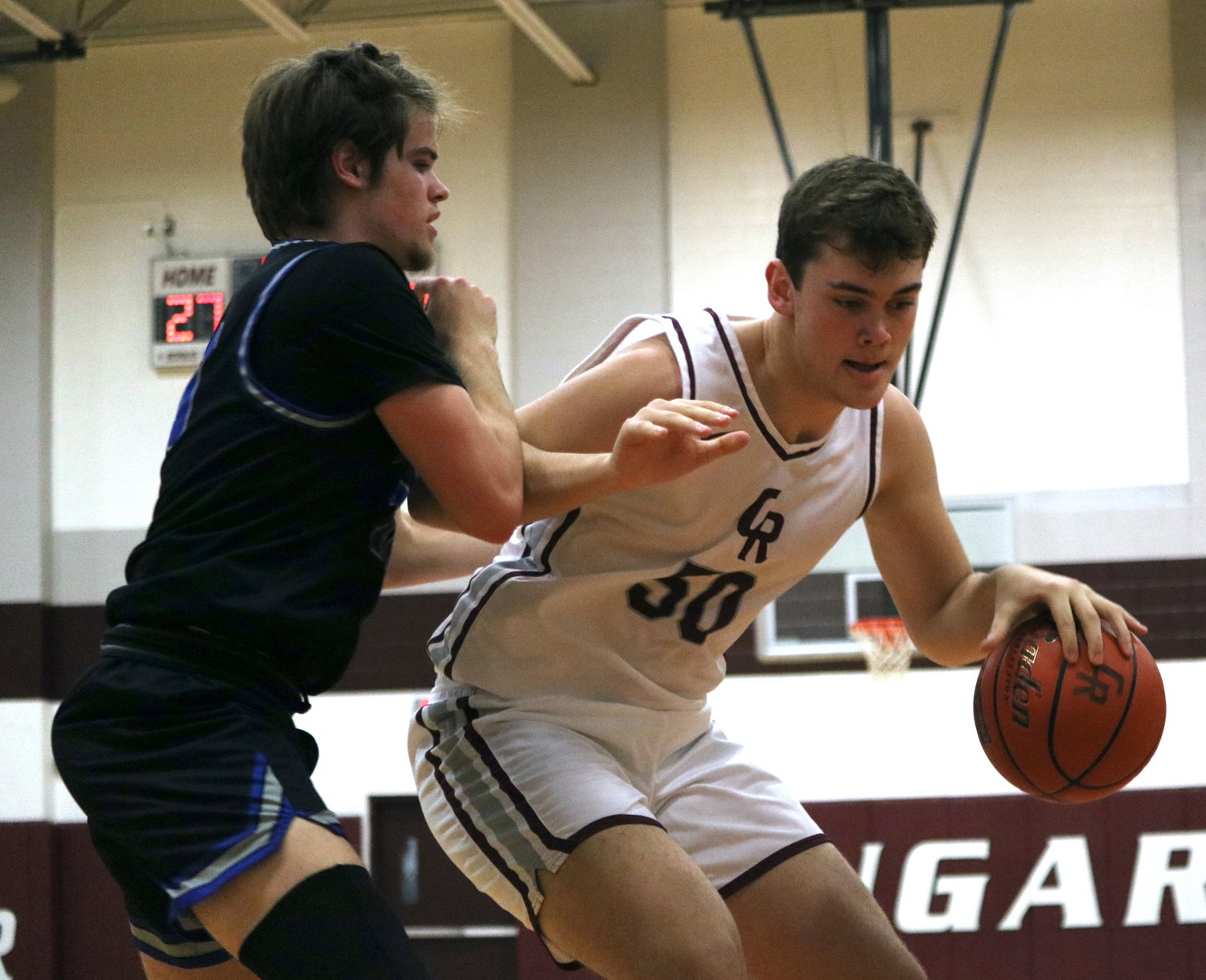 Harrison Moore backs down a defender during Wednesday's game between Cinco Ranch and Taylor at the Cinco Ranch gym.