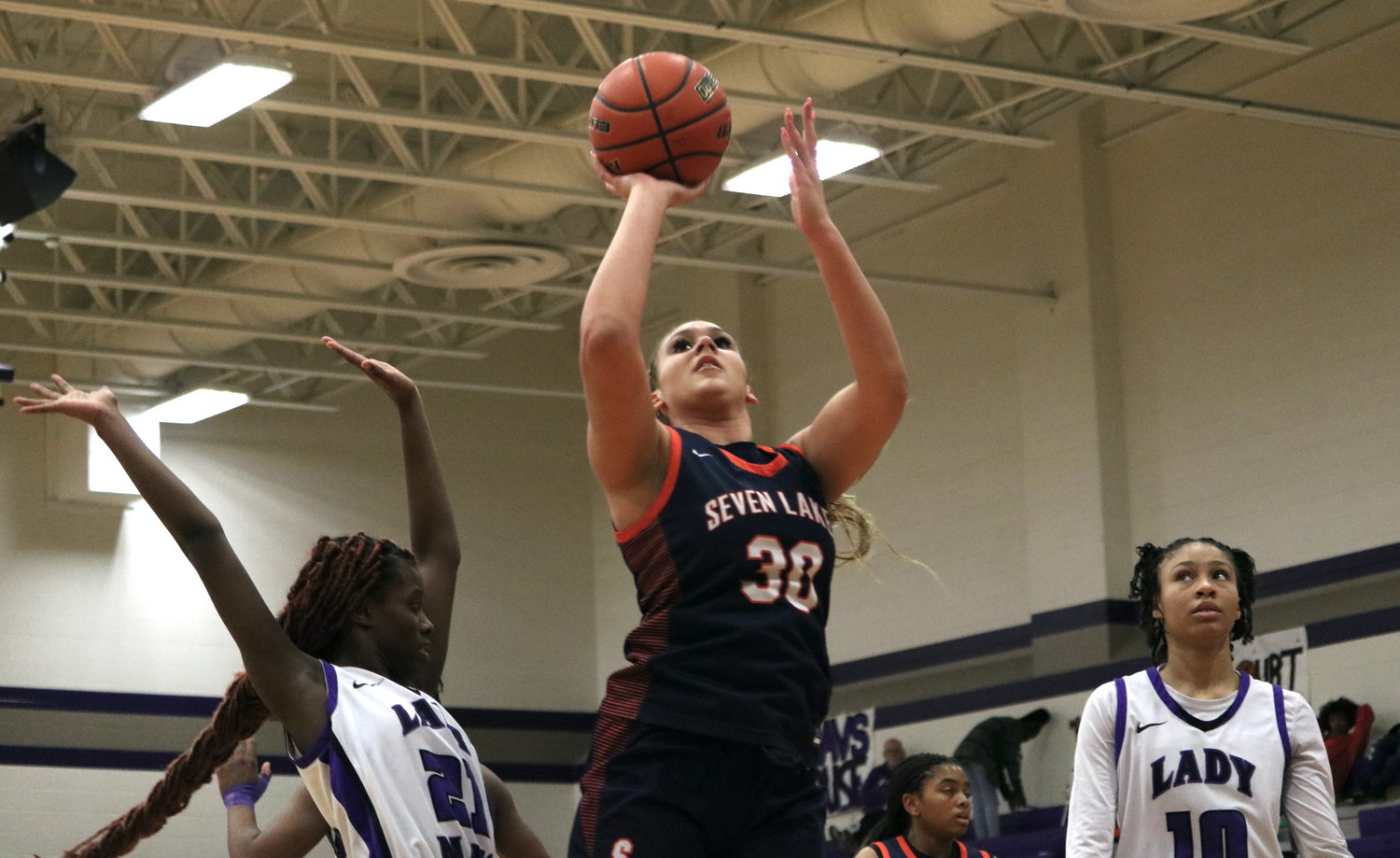 Justice Carlton shoots a floater during Friday's game between Seven Lakes and Morton Ranch at the Morton Ranch gym.
