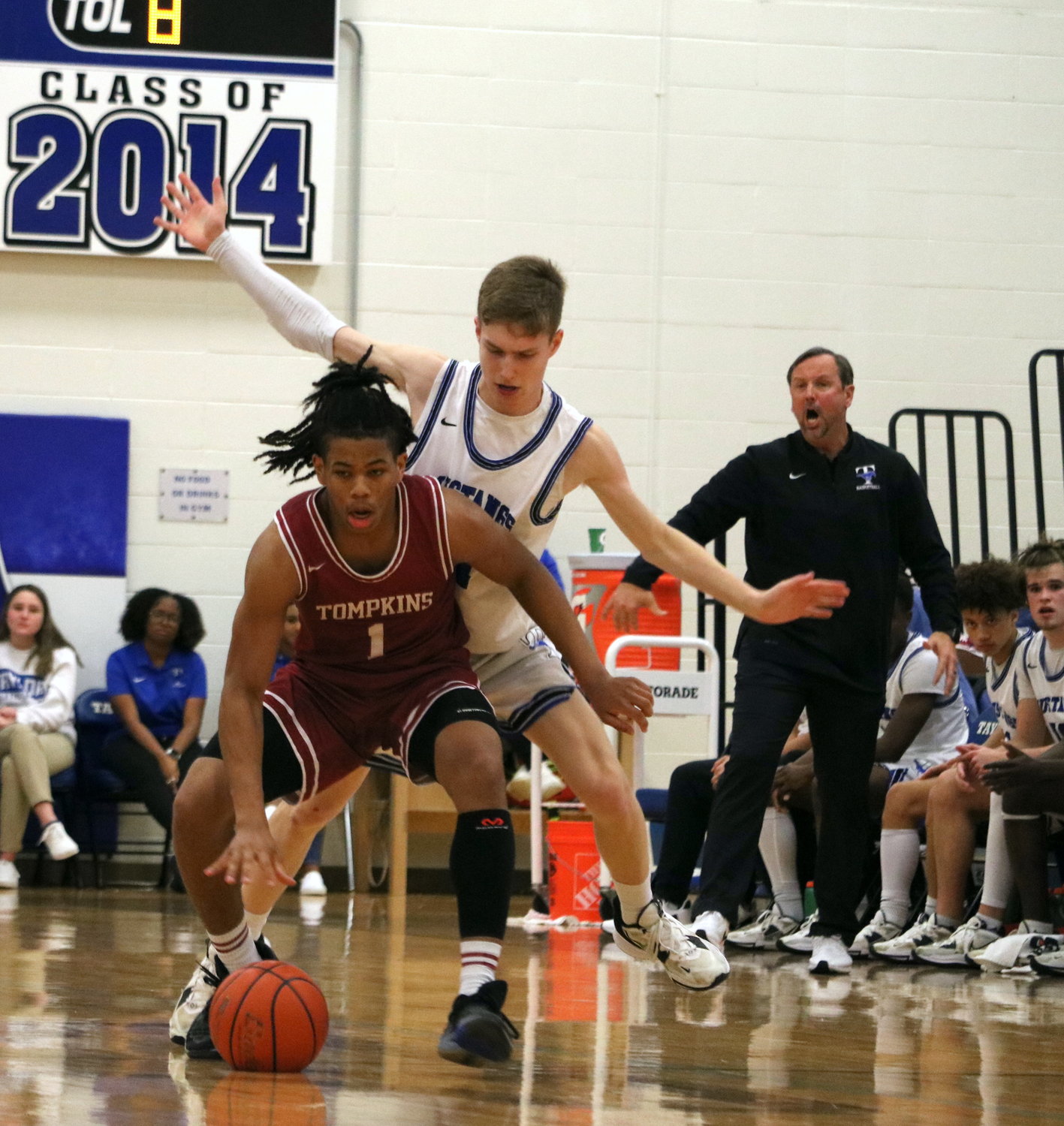 Scottie Guillory muscles off a defender while dribbling during Saturday's game between Tompkins and Taylor at the Taylor gym.