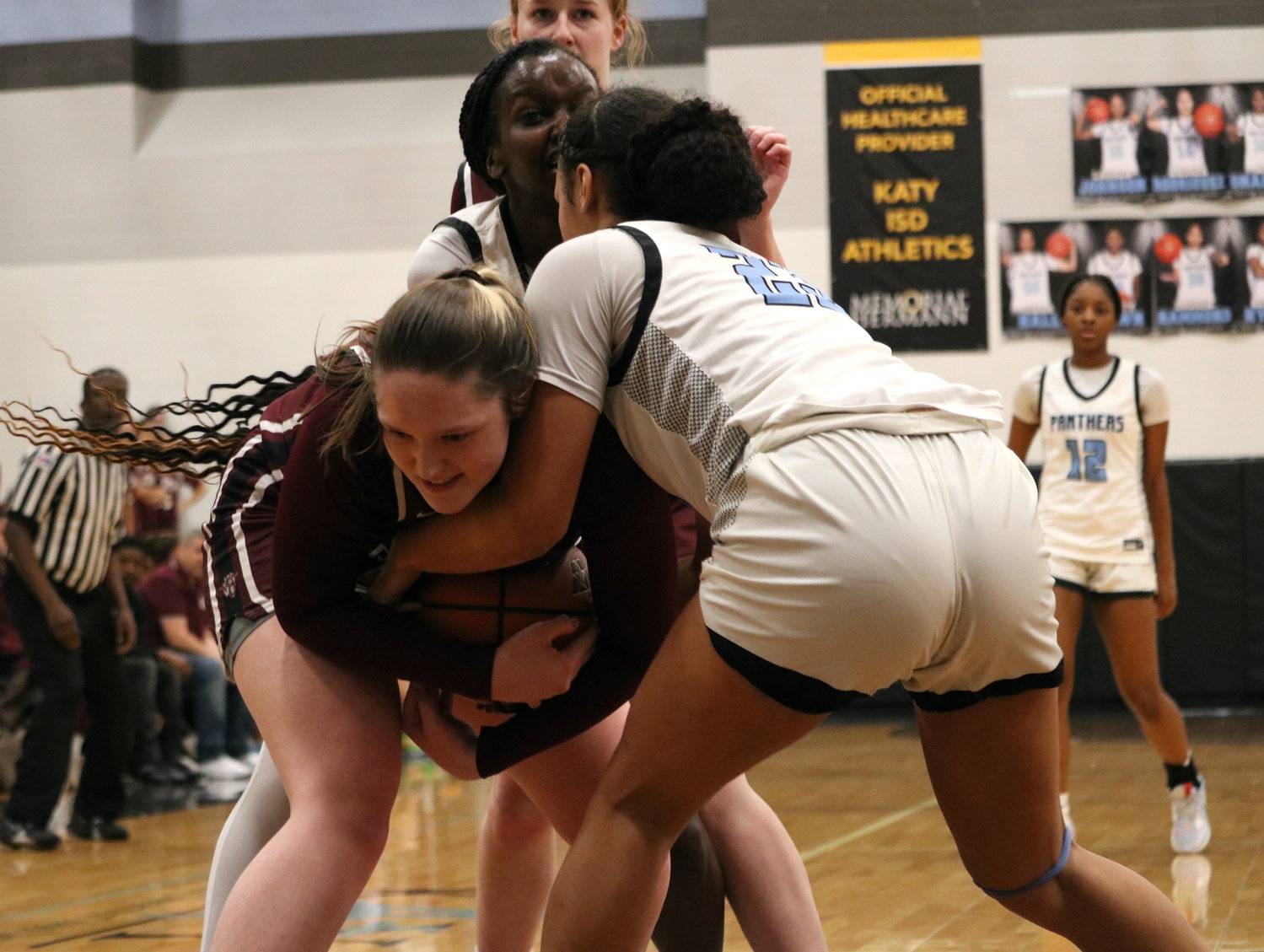 Sophie Baran fights for possession against Paetow defenders during Friday's game between Cinco Ranch and Paetow at the Paetow gym.