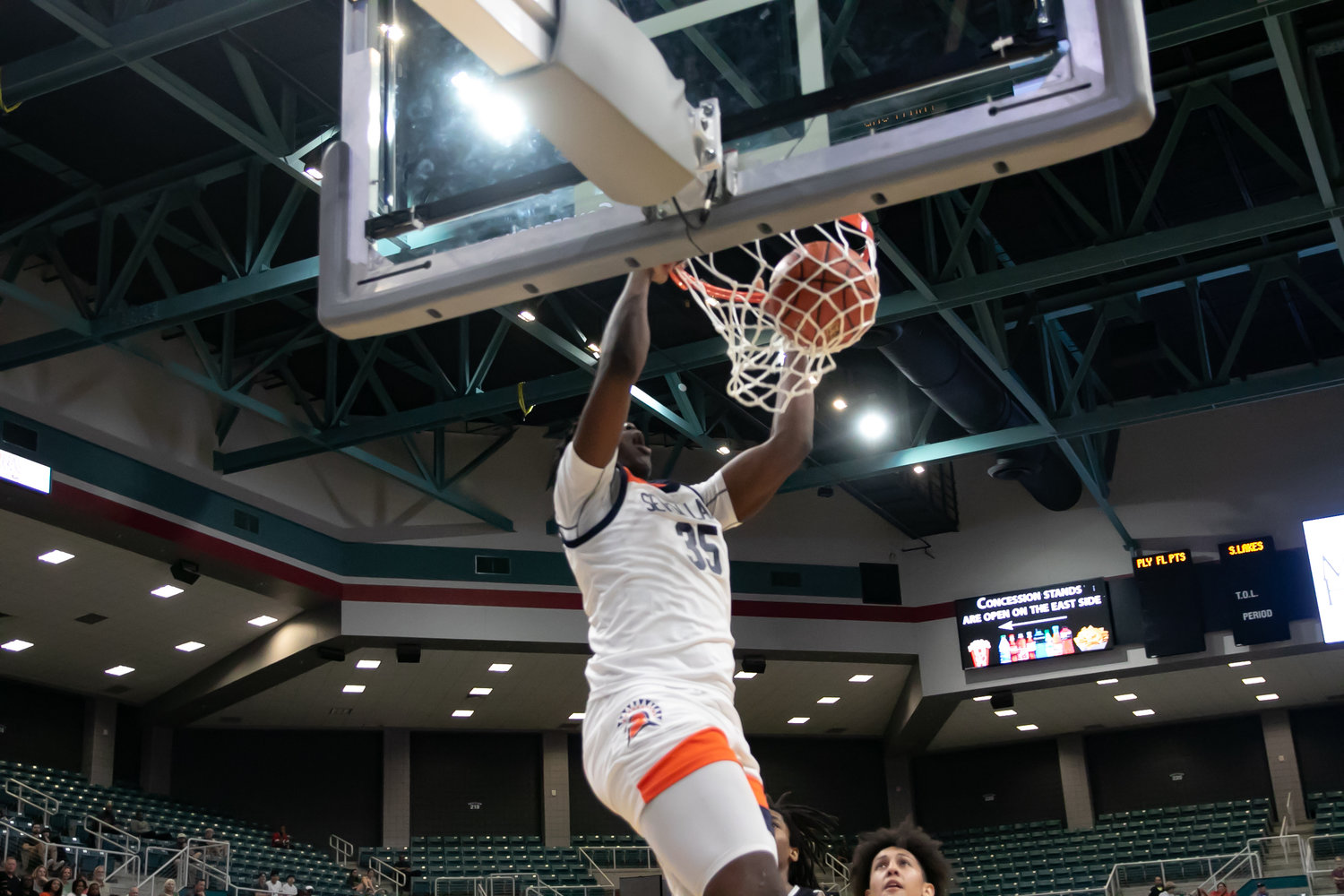 Josh Akpovwa throws down a dunk during Monday's Class 6A Regional Quarterfinal between Seven Lakes and Stratford at the Merrell Center.