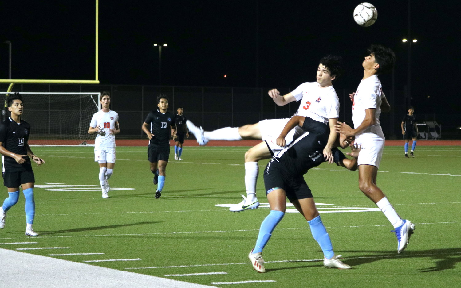 Jose Dominguez and Diego Flamenco collide while going for a header during Tuesday's District 19-6A game between Seven Lakes and Paetow at the Paetow soccer field.