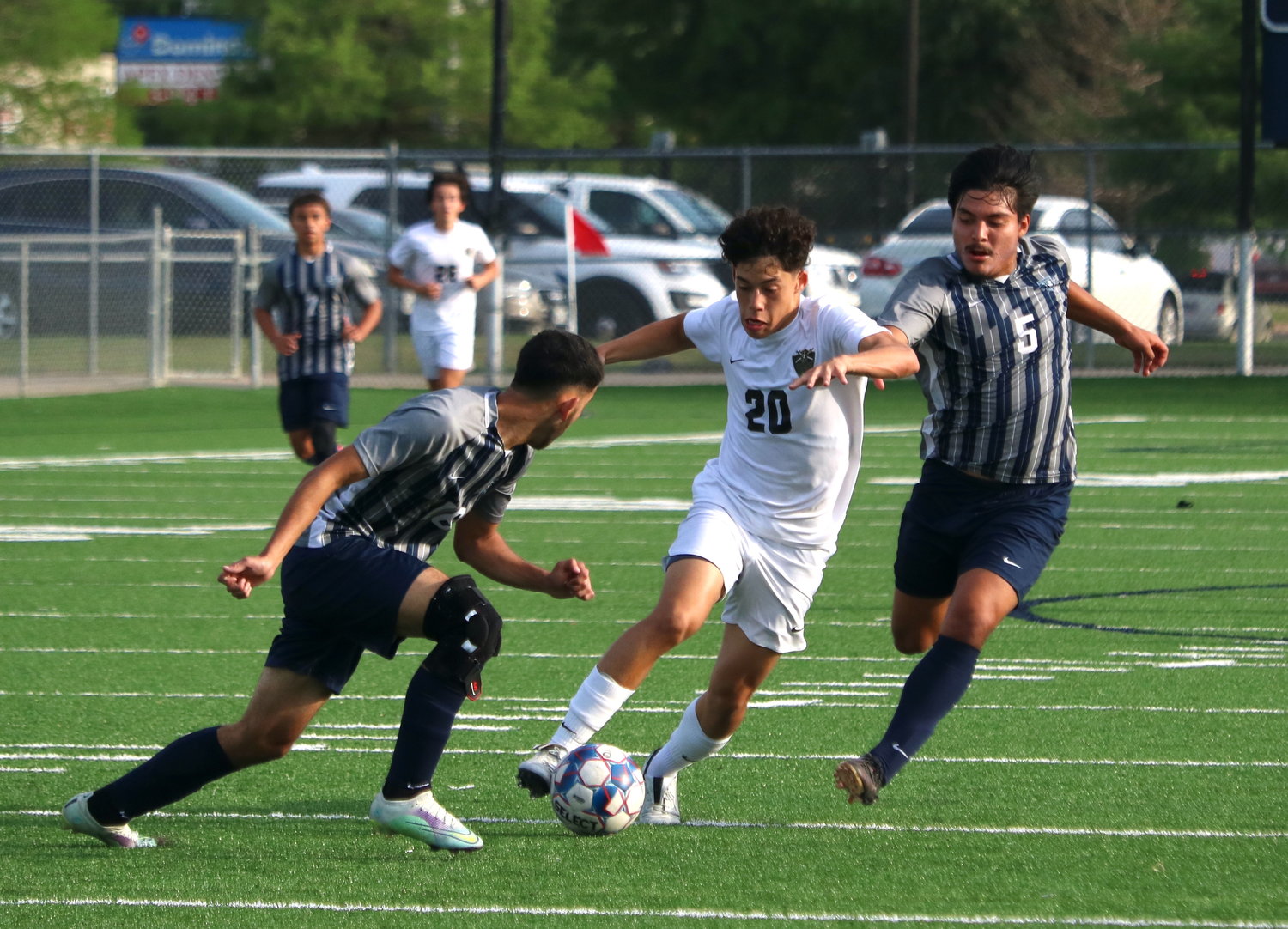 Kevin Sanoja dribbles through defenders during Tuesday's match between Jordan and Cy-Ridge at the Spring Woods football field.