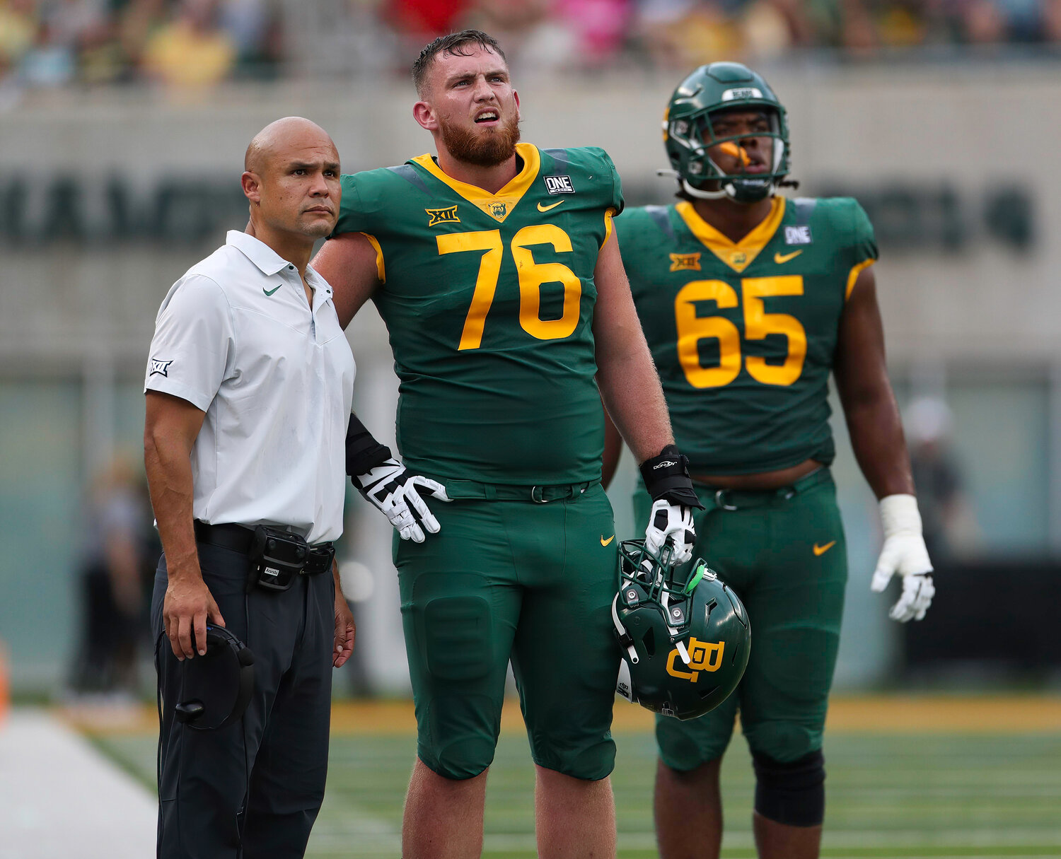 Baylor offensive lineman Connor Galvin (76) and offensive lineman Micah Mazzccua (65) watch the video board with head coach Dave Aranda during a college football game between Baylor and Albany in Waco, Texas, on Sept. 3, 2022.