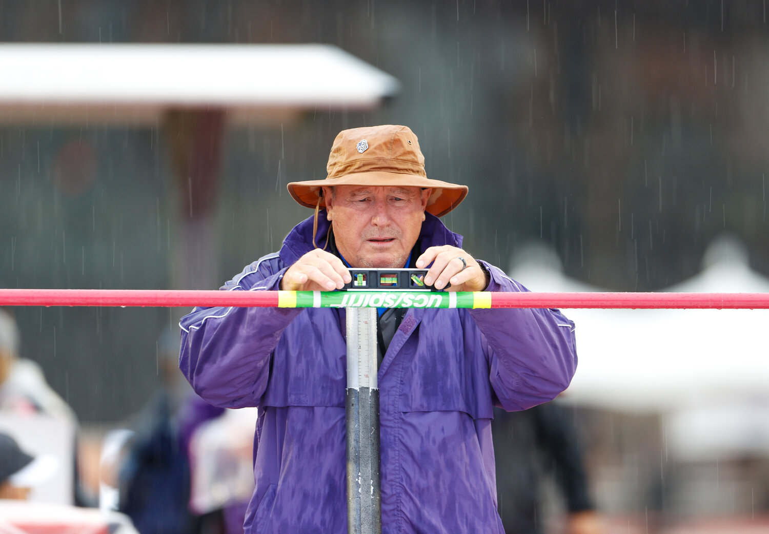 Meet officials prepare the high jump venue at the UIL State Track and Field Meet on a rainy Saturday morning, May 13, 2023 in Austin.